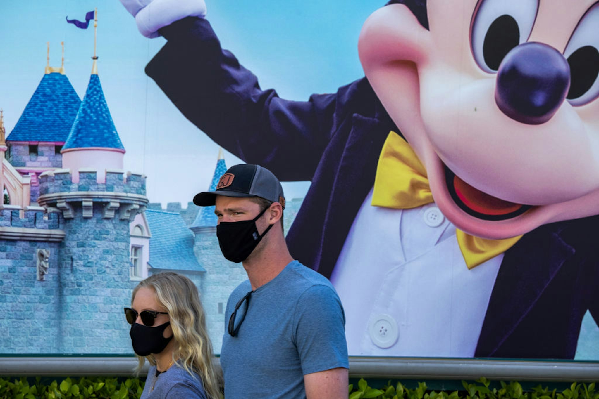 People enter Disneyland Park as it reopens for the first time since the COVID 19 pandemic forced the park to shut down last year on April 30, 2021 in Anaheim, California.
