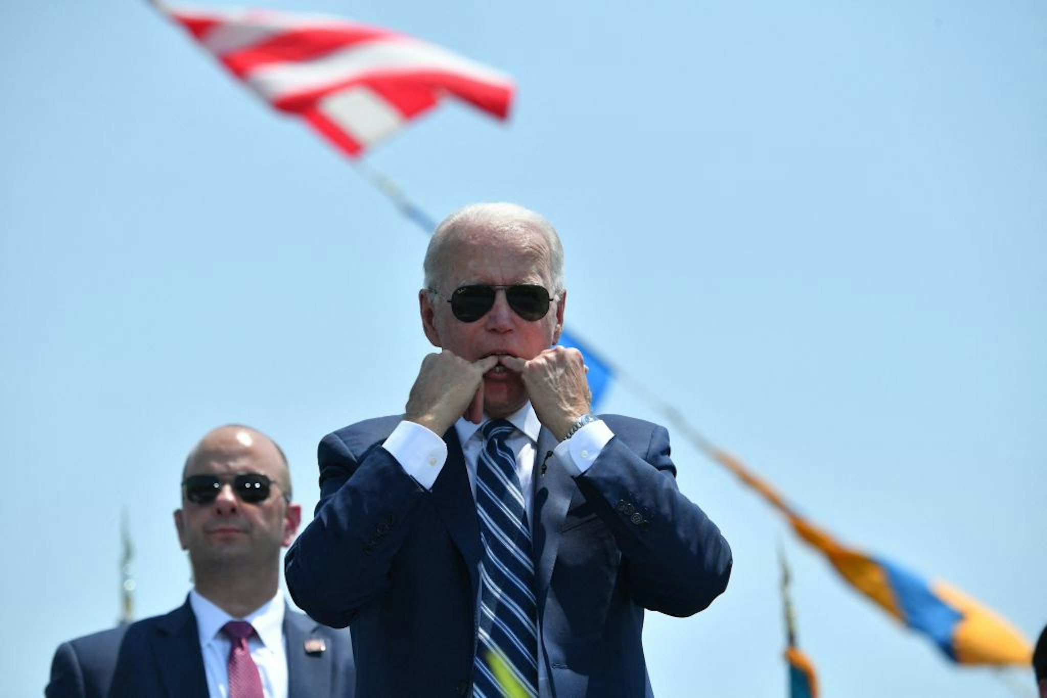 US President Joe Biden whistles during the US Coast Guard Academys 140th commencement exercises on May 19, 2021 in New London, Connecticut.