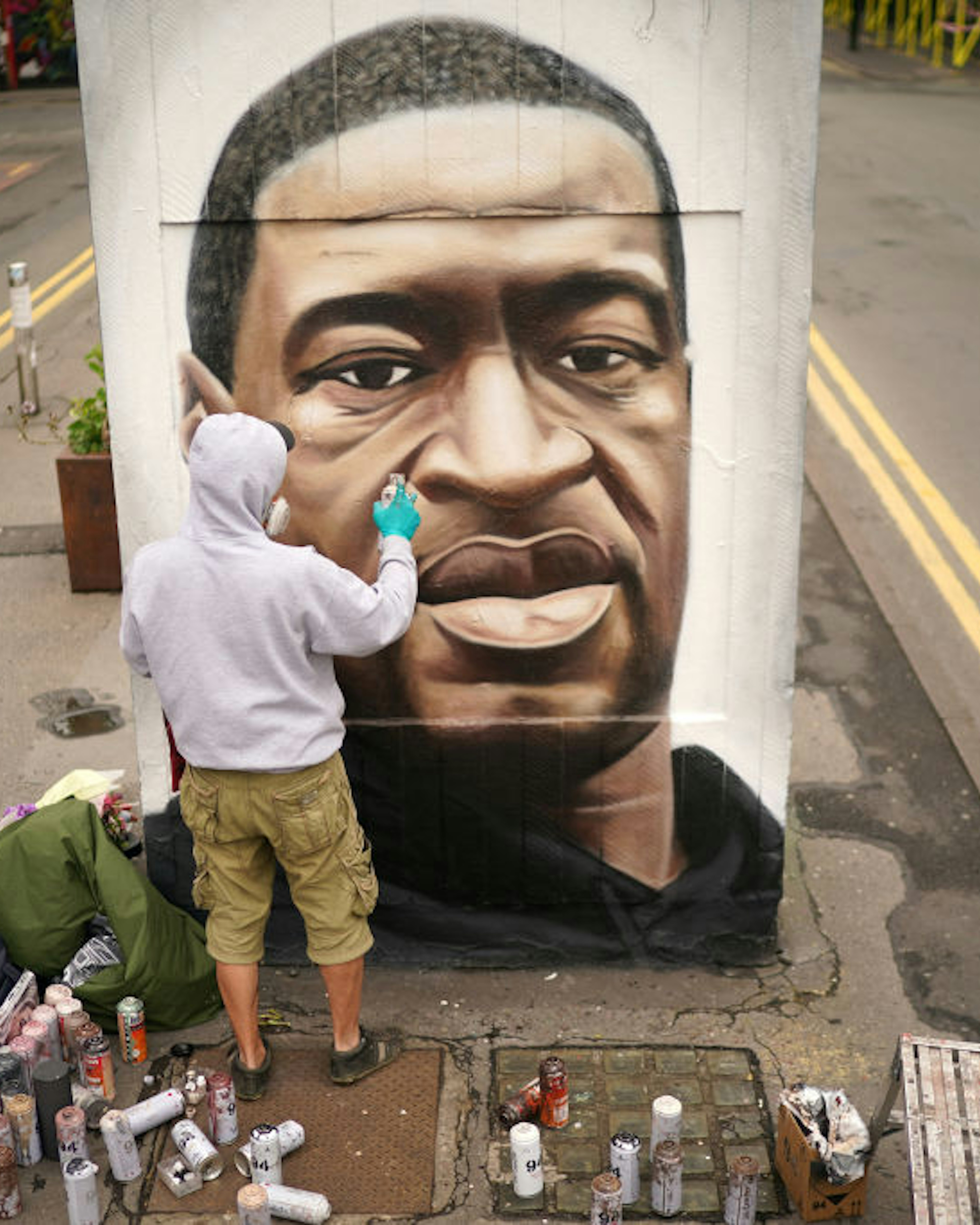 MANCHESTER, UNITED KINGDOM - JUNE 03: Graffiti artist Akse spray paints a mural of George Floyd in Manchester's northern quarter on June 03, 2020 in Manchester, United Kingdom. The death of an African-American man, George Floyd, while in the custody of Minneapolis police has sparked protests across the United States, as well as demonstrations of solidarity in many countries around the world. (Photo by Christopher Furlong/Getty Images)