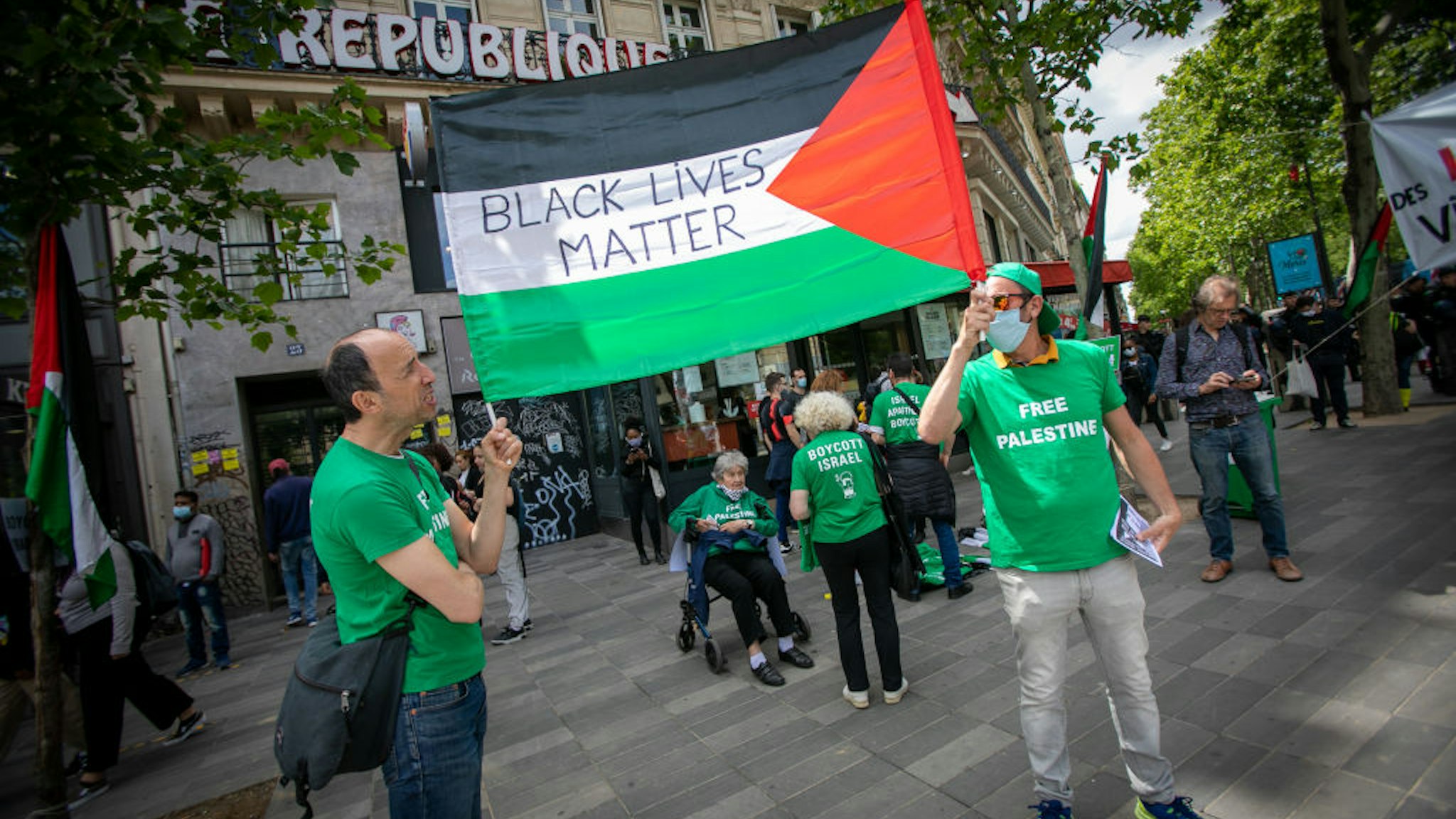 PARIS, FRANCE - JUNE 13: A banner on the palestinian flag is carried during a rally as part of the 'Black Lives Matter' worldwide protests against racism and police brutality on Place de la Republique on June 13, 2020 in Paris, France. People gathered in support of Adama Traore, a Malian French man who died in 2016 after being restrained by police in Paris. (Photo by Marc Piasecki/Getty Images)
