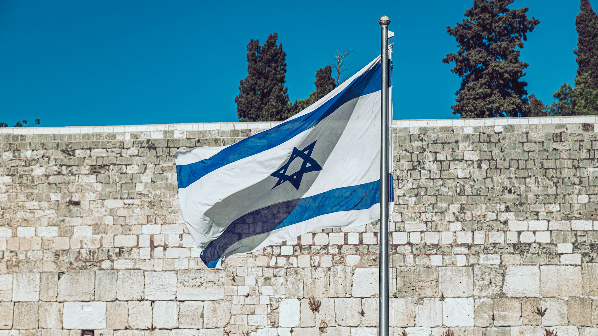 Israeli flag against Western Wall