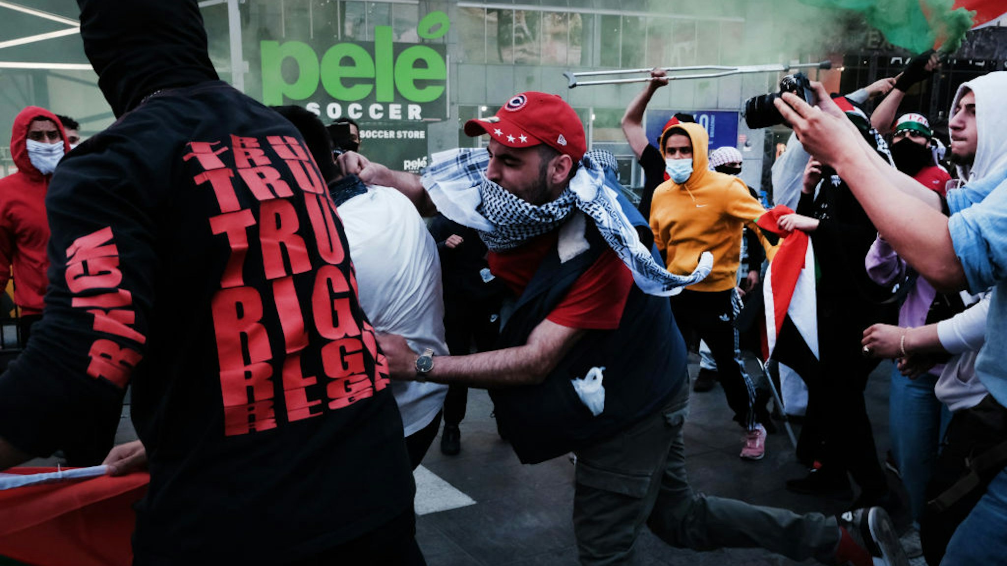 NEW YORK, NY - MAY 20: Pro Palestinian protesters face off with a group of Israel supporters and police in a violent clash in Times Square on May 20, 2021 in New York City. Despite an announcement of a cease fire between Israel and Gaza militants, dozens of supporters of both sides of the conflict fought in the streets of Times Square. Dozens were arrested and detained by police before they were dispersed out of the square. The 11 days of fighting has claimed the lives of at least 232 people in Gaza and 12 in Israel. (Photo by Spencer Platt/Getty Images)