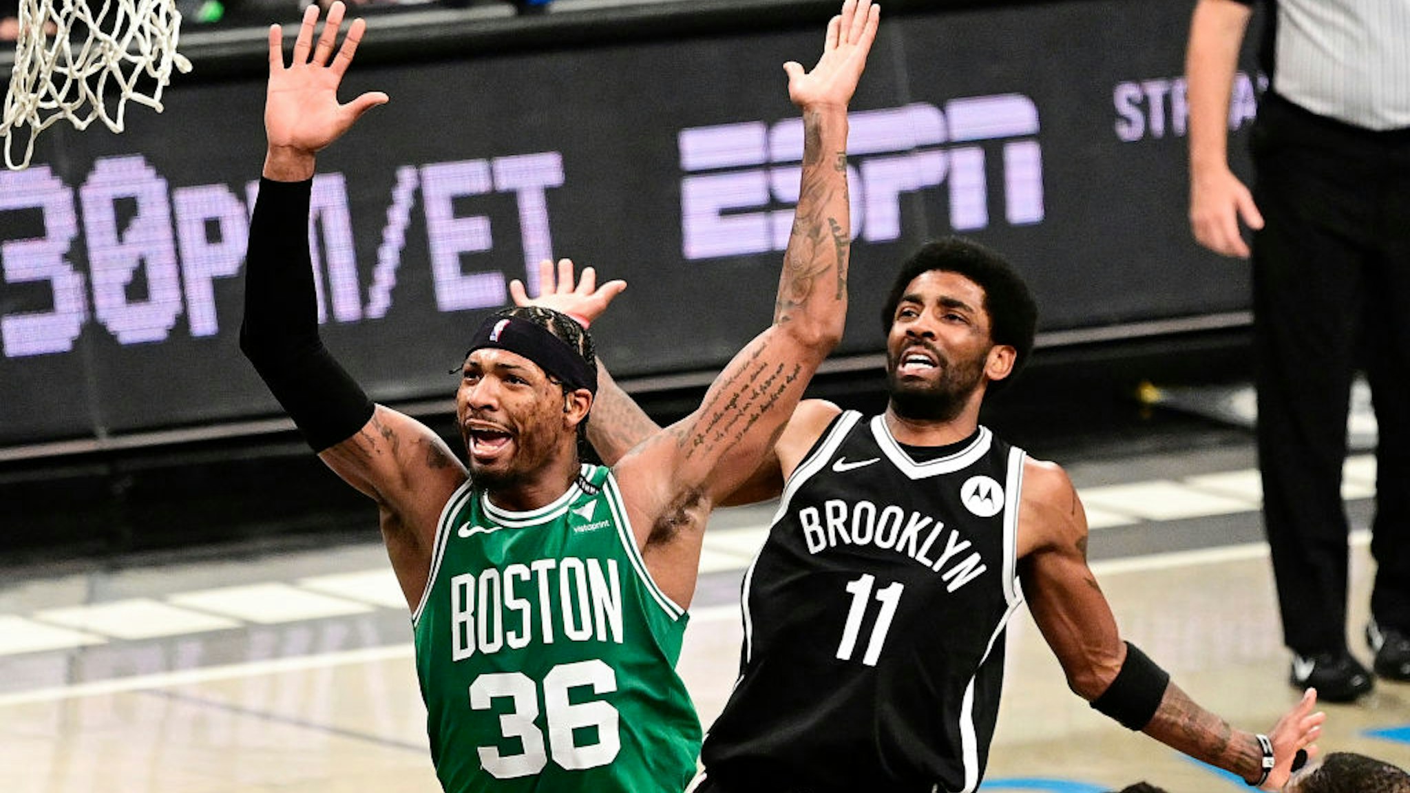 NEW YORK, NEW YORK - MAY 22: Marcus Smart #36 of the Boston Celtics is fouled by Kyrie Irving #11 of the Brooklyn Nets in Game One of the First Round of the 2021 NBA Playoffs at Barclays Center at Barclays Center on May 22, 2021 in New York City. NOTE TO USER: User expressly acknowledges and agrees that, by downloading and or using this photograph, User is consenting to the terms and conditions of the Getty Images License Agreement. (Photo by Steven Ryan/Getty Images)