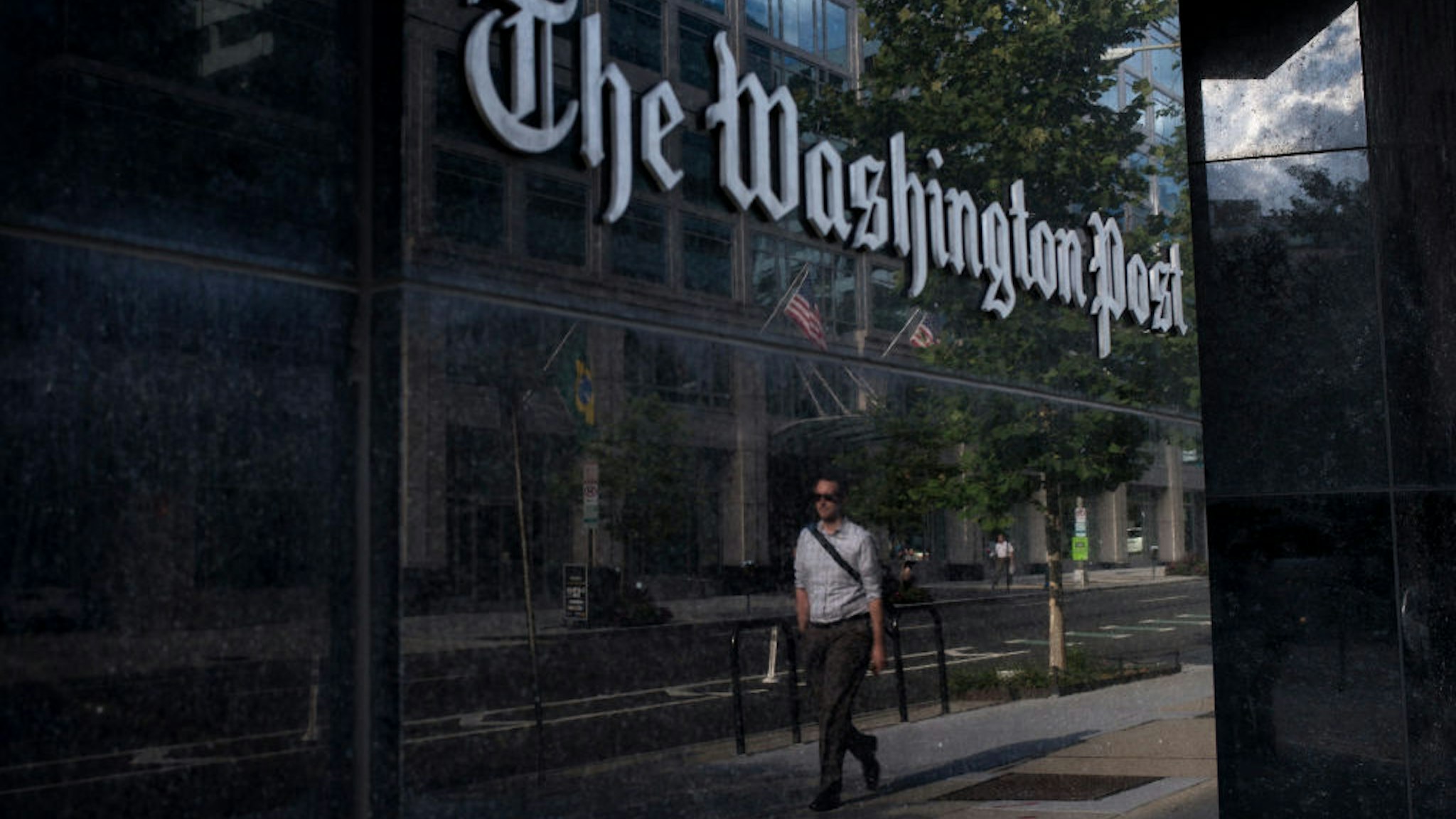 A man walks past The Washington Post on August 5, 2013 in Washington, DC after it was announced that Amazon.com founder and CEO Jeff Bezos had agreed to purchase the Post for USD 250 million.