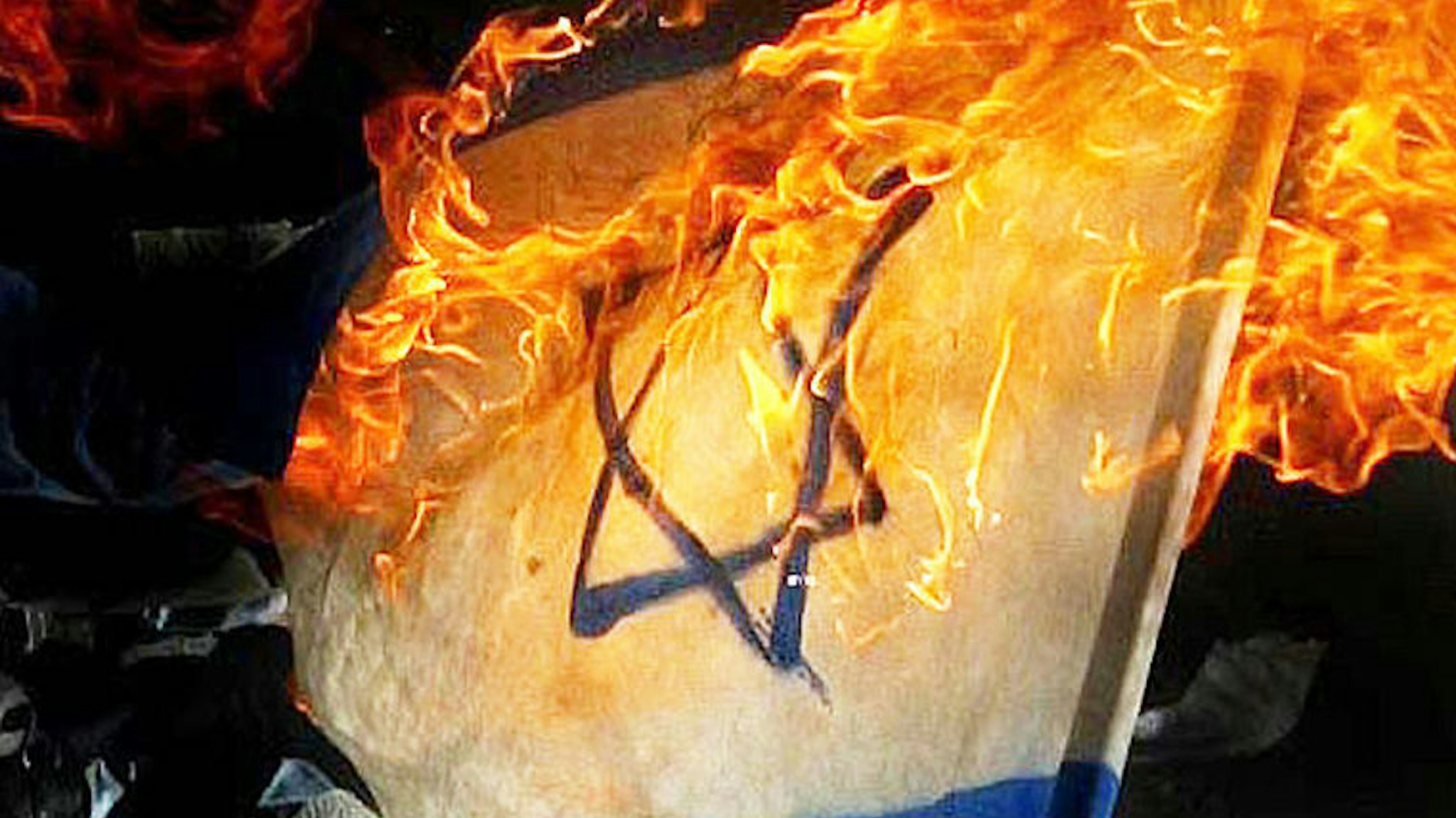 The Israeli flag is burned by Palestinian militants during an anti-Israel rally on April 17, 2004, in Gaza, Gaza Strip.