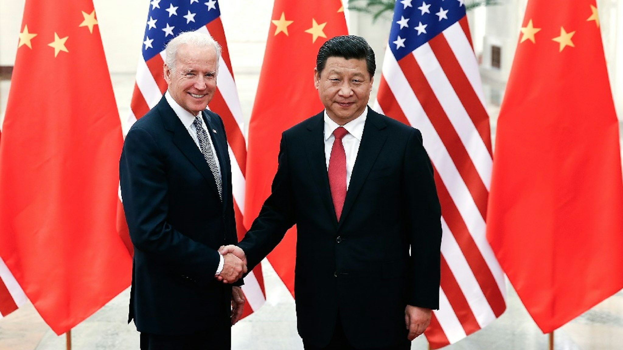 BEIJING, CHINA - DECEMBER 04: Chinese President Xi Jinping (R) shake hands with U.S Vice President Joe Biden (L) inside the Great Hall of the People on December 4, 2013 in Beijing, China.