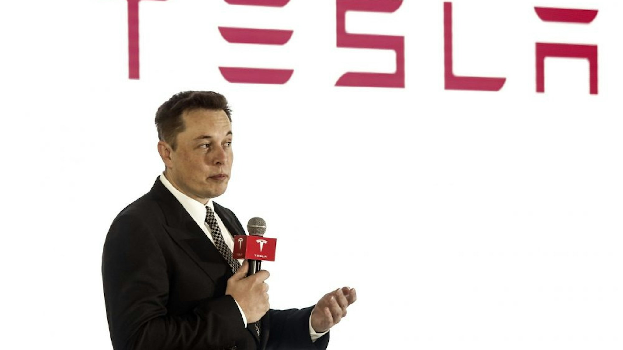 BEIJING, CHINA - OCTOBER 23: (CHINA OUT) Elon Musk, Chairman, CEO and Product Architect of Tesla Motors, addresses a press conference to declare that the Tesla Motors releases v7.0 System in China on a limited basis for its Model S, which will enable self-driving features such as Autosteer for a select group of beta testers on October 23, 2015 in Beijing, China. The v7.0 system includes Autosteer, a new Autopilot feature. While it's not absolutely self-driving and the driver still need to hold the steering wheel and be mindful of road conditions and surrounding traffic when using Autosteer. When set to the new Autosteer mode, graphics on the driver's display will show the path the Model S is following, post the current speed limit and indicate if a car is in front of the Tesla.