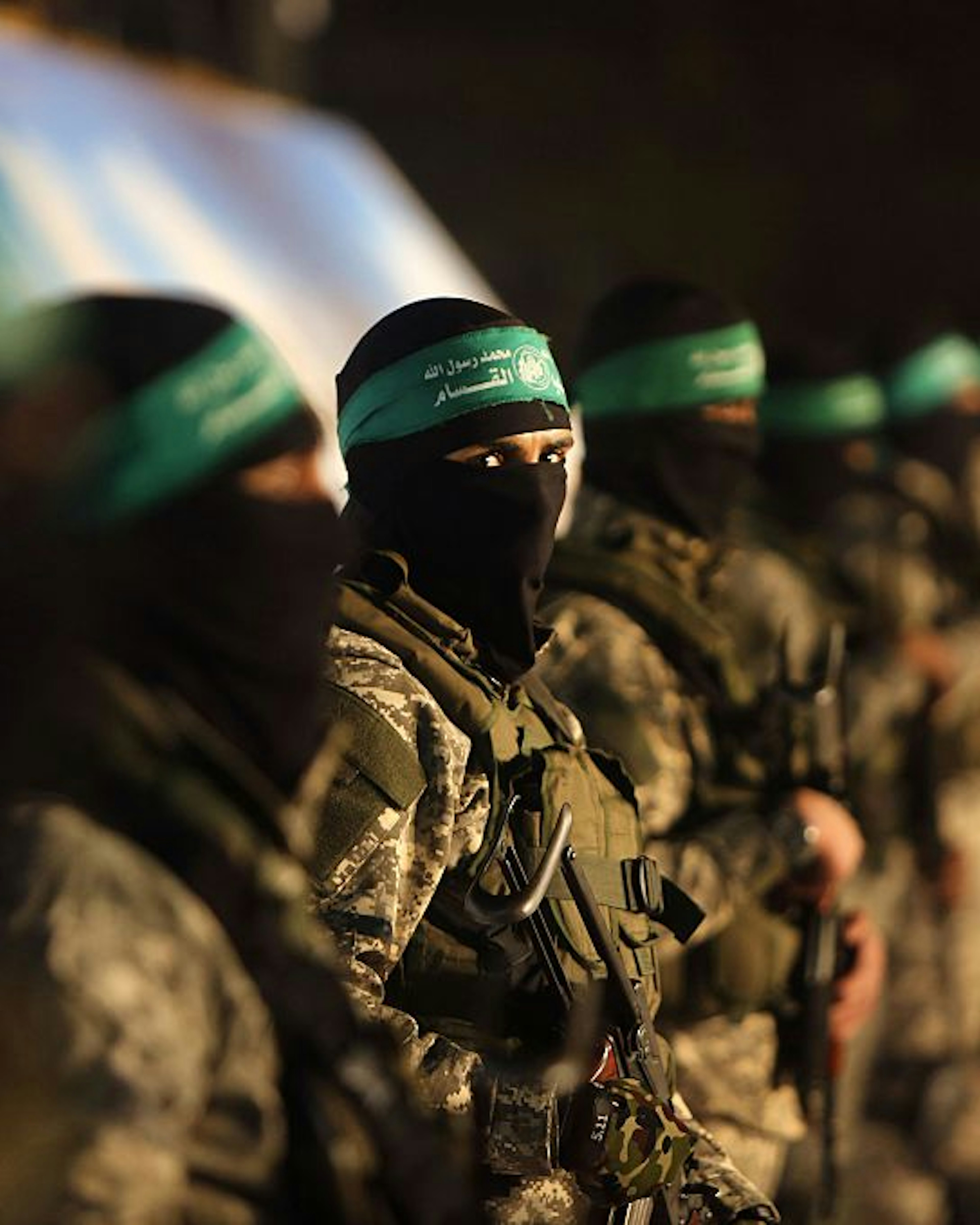 TOPSHOT - Palestinian members of the Ezzedine al-Qassam Brigades, the armed wing of the Hamas movement, take part in a gathering on January 31, 2016 in Gaza city to pay tribute to their fellow militants who died after a tunnel collapsed in the Gaza Strip.