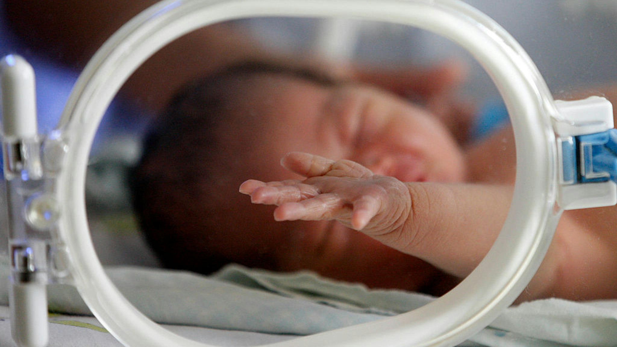 new baby is laying on a bed in a hosiptal in Huaibei, Anhui province, China on 12th November 2013. On Thursday, the government said it was relaxing the rules to allow all couples to have two children. (Photo by Jie Zhao/Corbis via Getty Images)