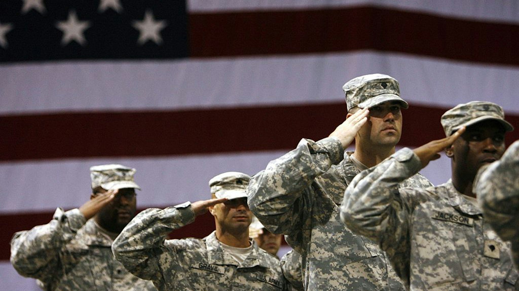 FORT RILEY, KS - SEPTEMBER 12: Soldiers stand saluting during the national anthem for the redeployment ceremony at Marshall Army Air Field inside hanger 727 for the 1st Battalion, 16th Infantry Regiment, 1st Brigade, 1st Infantry Division September 12, 2007 at Fort Riley, Kansas. The approximately 130 soldiers were returning after a one year tour in Iraq.