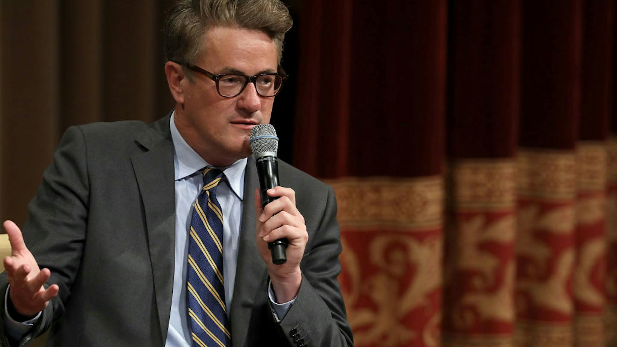 MSNBC TV Hosts Joe Scarborough And Mika Brzezinski Interviewed By Philanthropist And Financier David Rubenstein In DC WASHINGTON, DC - JULY 12: MSNBC 'Morning Joe' host Joe Scarborough speaks during an interview with his co-host Mika Brzezinski and philanthropist and financier David Rubenstein during a Harvard Kennedy School Institute of Politics event in the McGowan Theater at the National Archives July 12, 2017 in Washington, DC. Scarborough and Brzezinski, who are engaged to be married, were recently attacked by President Donald Trump on Twitter, where he called the hosts 'Psycho Joe' and 'low I.Q. Crazy Mika,' among other personal insults. (Photo by Chip Somodevilla/Getty Images)