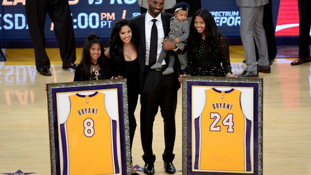LOS ANGELES, CA - DECEMBER 18: Kobe Bryant poses with his family at halftime after both his #8 and #24 Los Angeles Lakers jerseys are retired at Staples Center on December 18, 2017 in Los Angeles, California. NOTE TO USER: User expressly acknowledges and agrees that, by downloading and or using this photograph, User is consenting to the terms and conditions of the Getty Images License Agreement. (Photo by Maxx Wolfson/Getty Images)