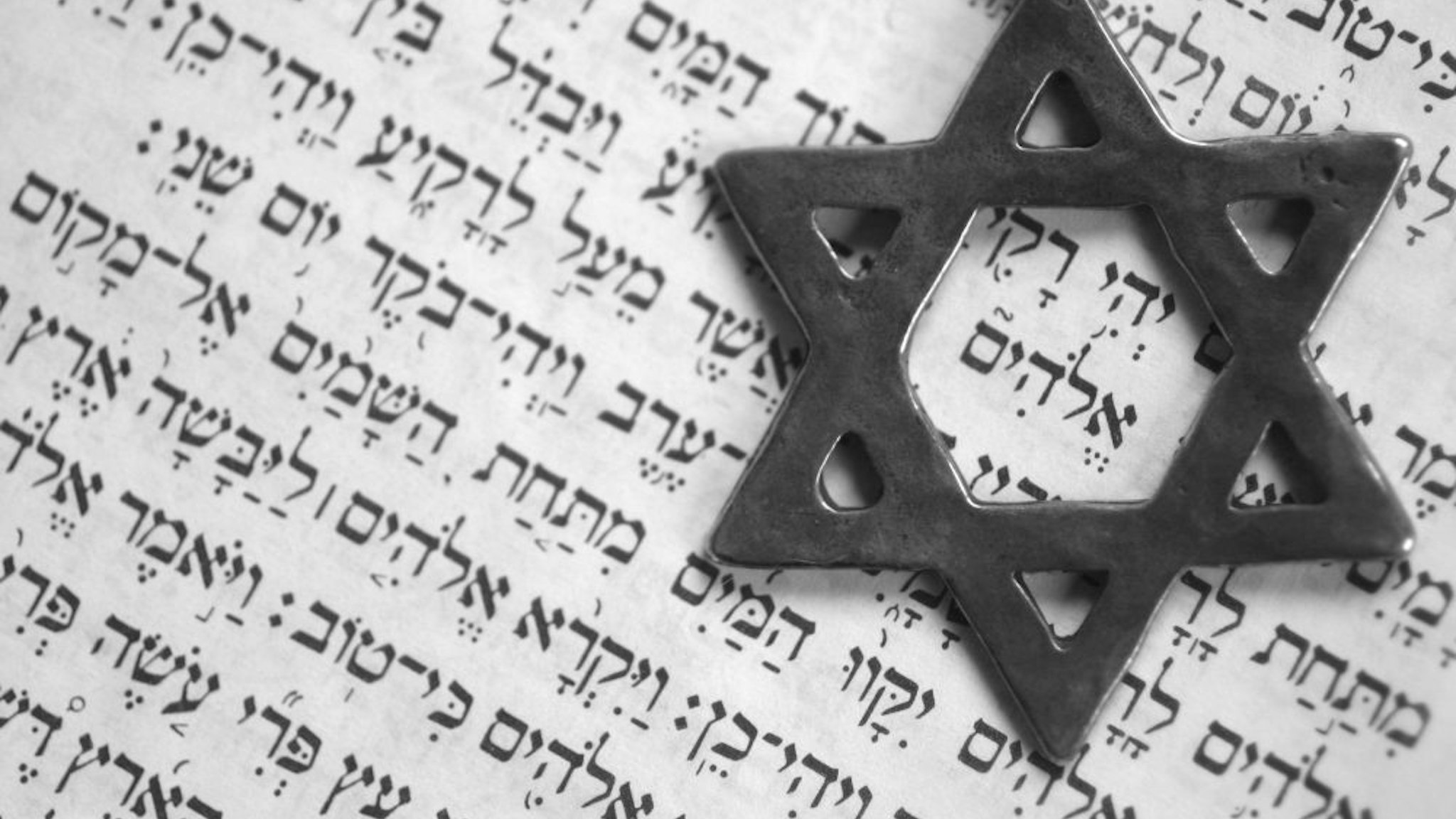 Star of David over the first page of the old testament in Hebrew. The word in the center of the star means "God".