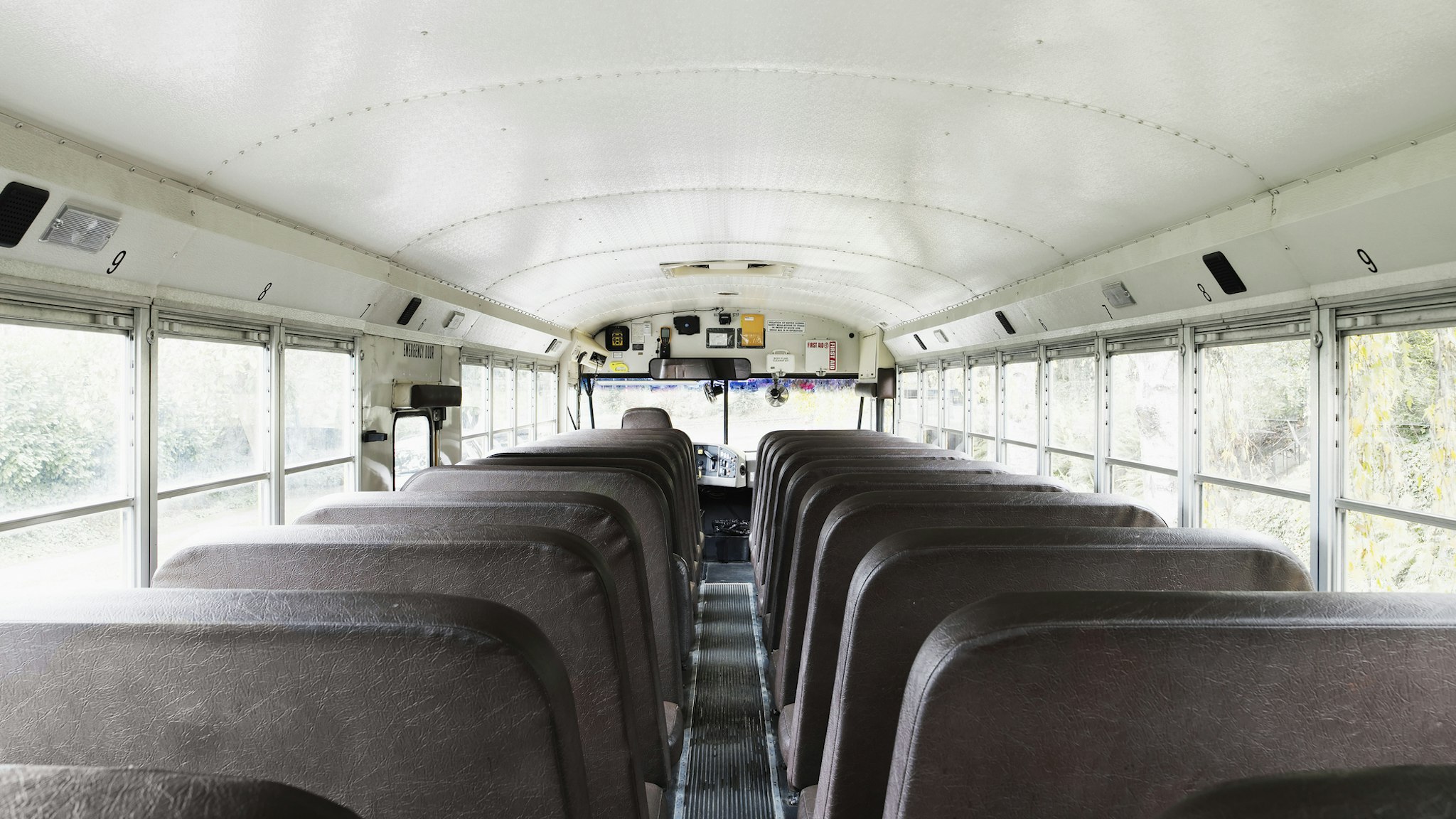 Interior view of empty school bus - stock photo