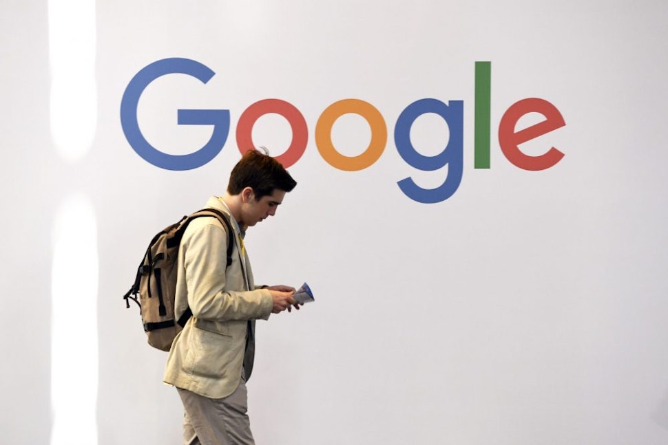 A man walks past the logo of the US multinational technology company Google during the VivaTech trade fair ( Viva Technology), on May 24, 2018 in Paris.