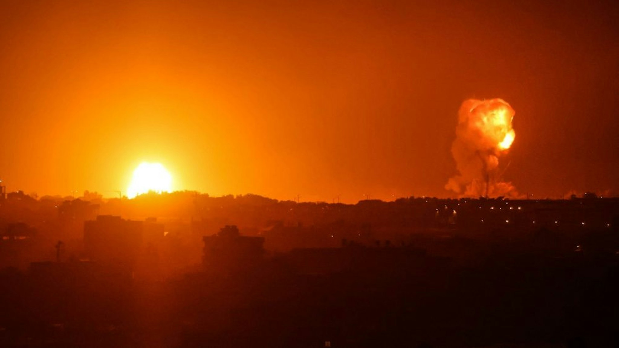 Fire billows from Israeli air strikes in Rafah, in the southern Gaza Strip, on May 11, 2021. - Israel launched deadly air strikes on Gaza on May 10 in response to a barrage of rockets fired by Hamas and other Palestinian militants, amid spiralling violence sparked by unrest at Jerusalem's Al-Aqsa Mosque compound.