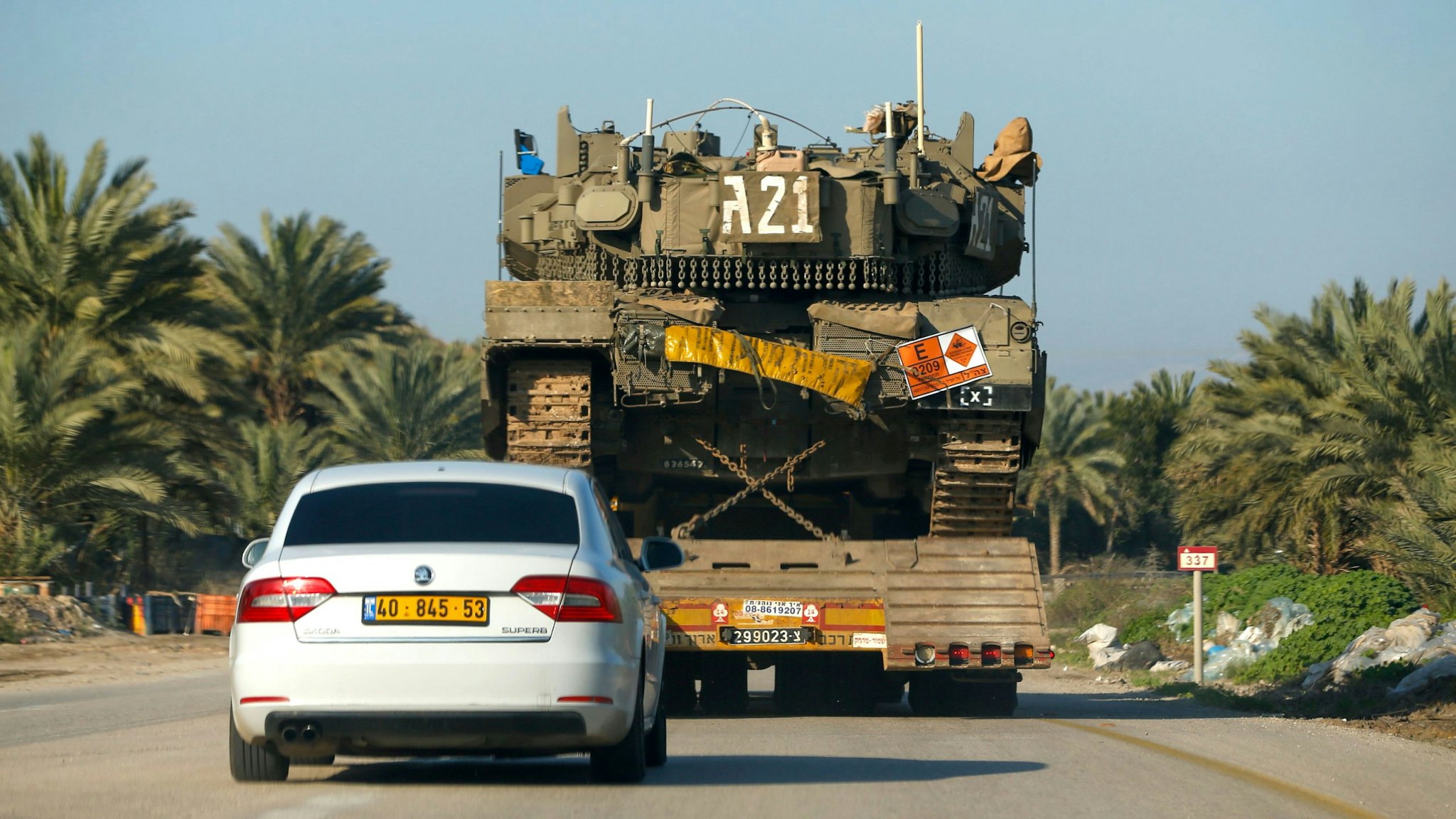 A general view taken on March 3, 2020, shows an Israeli Merkava IV battle tank being transported past an agricultural field near the settlement of Mehola in the Jordan valley in the occupied West Bank.