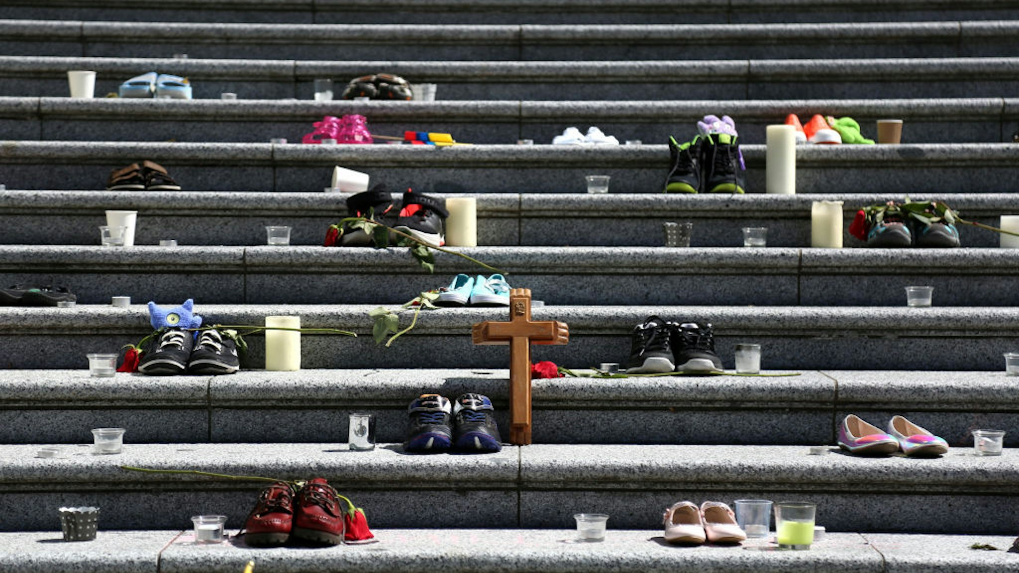 VANCOUVER, CANADA - MAY 29 : People gather outside Vancouver Art Gallery, where 215 pairs of kids shoes displayed on May 29, 2021 in Vancouver, British Columbia, Canada The remains of 215 children have been found buried at a Canadian residential school, an Indigenous band confirmed Thursday.