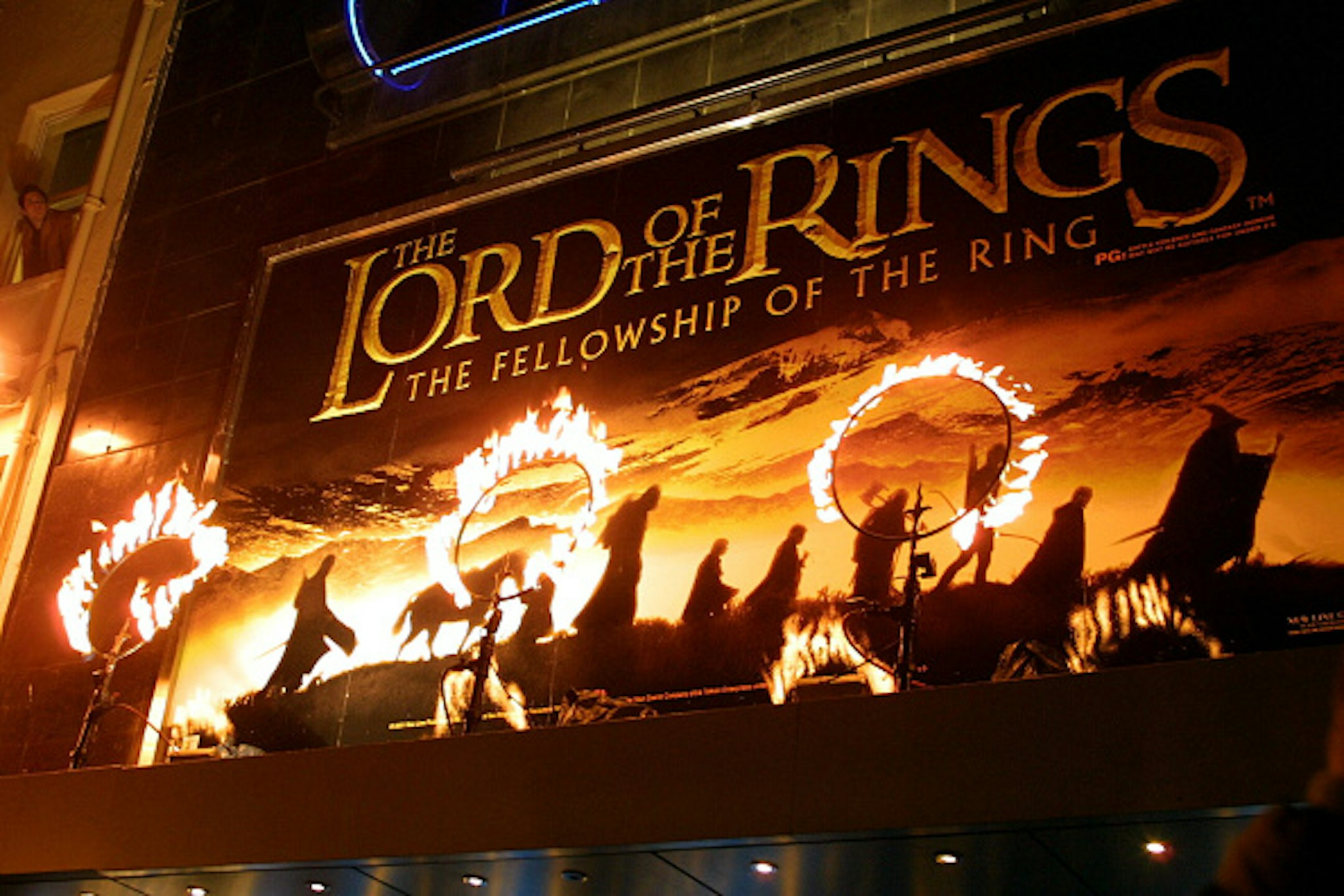Rings of fire burn near the movie poster for the film "The Lord of the Rings: The Fellowship of the Ring." The stars of the film attended the premiere in London.