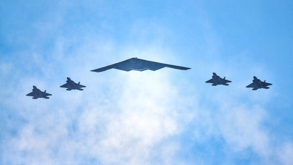 NEW YORK, NY - JULY 04: F-22 Raptors and a B-2 Stealth Bomber (C) fly over the Hudson River during the "Salute to America" military flyover on July 4, 2020 in New York City.