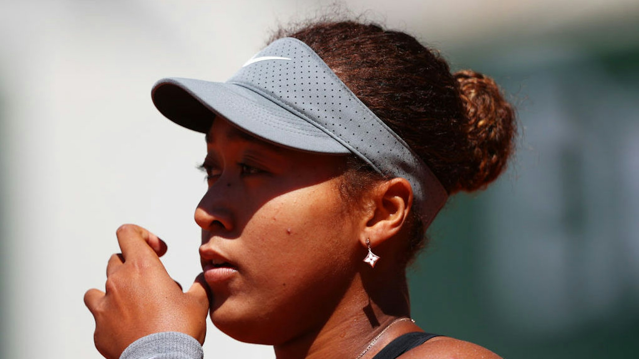 PARIS, FRANCE - MAY 30: Naomi Osaka of Japan looks on in her First Round match against Patricia Maria Tig of Romania during Day One of the 2021 French Open at Roland Garros on May 30, 2021 in Paris, France.