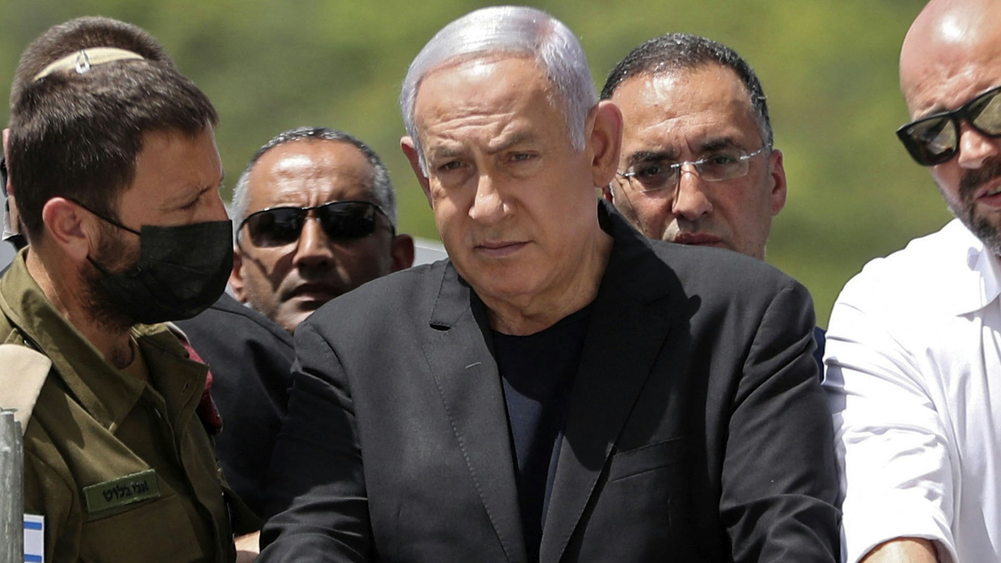 Israeli Prime Minister Benjamin Netanyahu (C) visits the site of an overnight stampede during an ultra-Orthodox religious gathering in the northern Israeli town of Meron, on April 30, 2021. - The massive stampede at the densely-packed site near the reputed tomb of Rabbi Shimon Bar Yochai, a second-century Talmudic sage, where mainly ultra-Orthodox Jews flock to mark the Lag BaOmer holiday, killed at least 44 people in northern Israel, blackening the country's largest COVID-era gathering.