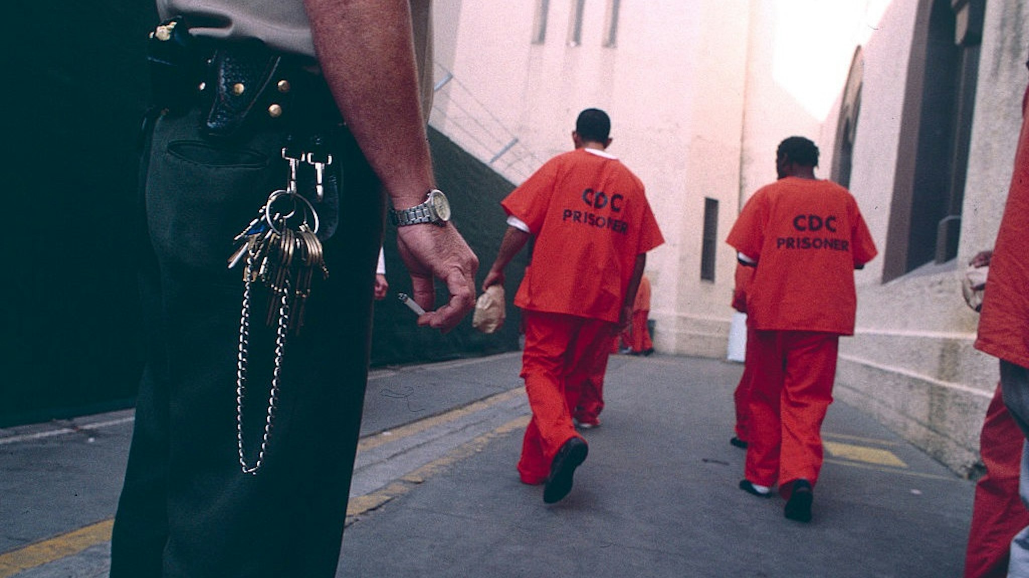 A California corrections officer watches over prisoners at San Quentin.