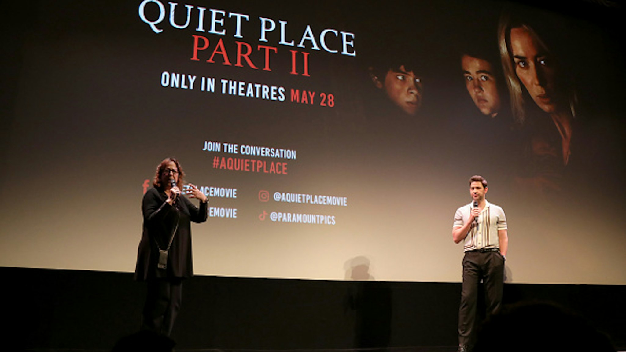 AUSTIN, TEXAS - MAY 28: Janet Pierson (L) and John Krasinski (R) speak onstage at the Austin screening of 'A Quiet Place Part II' at the The Paramount Theater on May 28, 2021 in Austin, Texas.