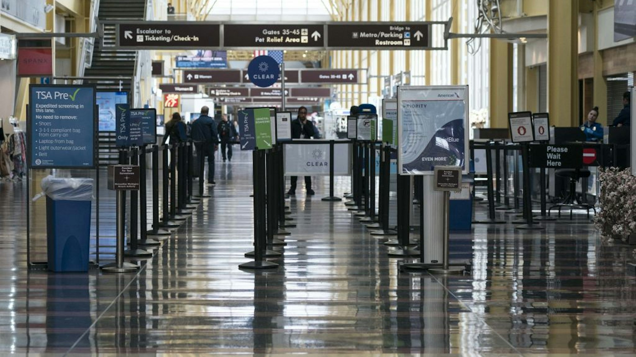 The TSA line is seen nearly empty at Ronald Reagan National Airport (DCA) in Arlington, Virginia, U.S., on Monday, March 16, 2020. The airline industry, ravaged by plummeting bookings due to the coronavirus, is seeking grants and loans totaling as much as $58 billion from the U.S. government as well as temporary relief from various taxes.