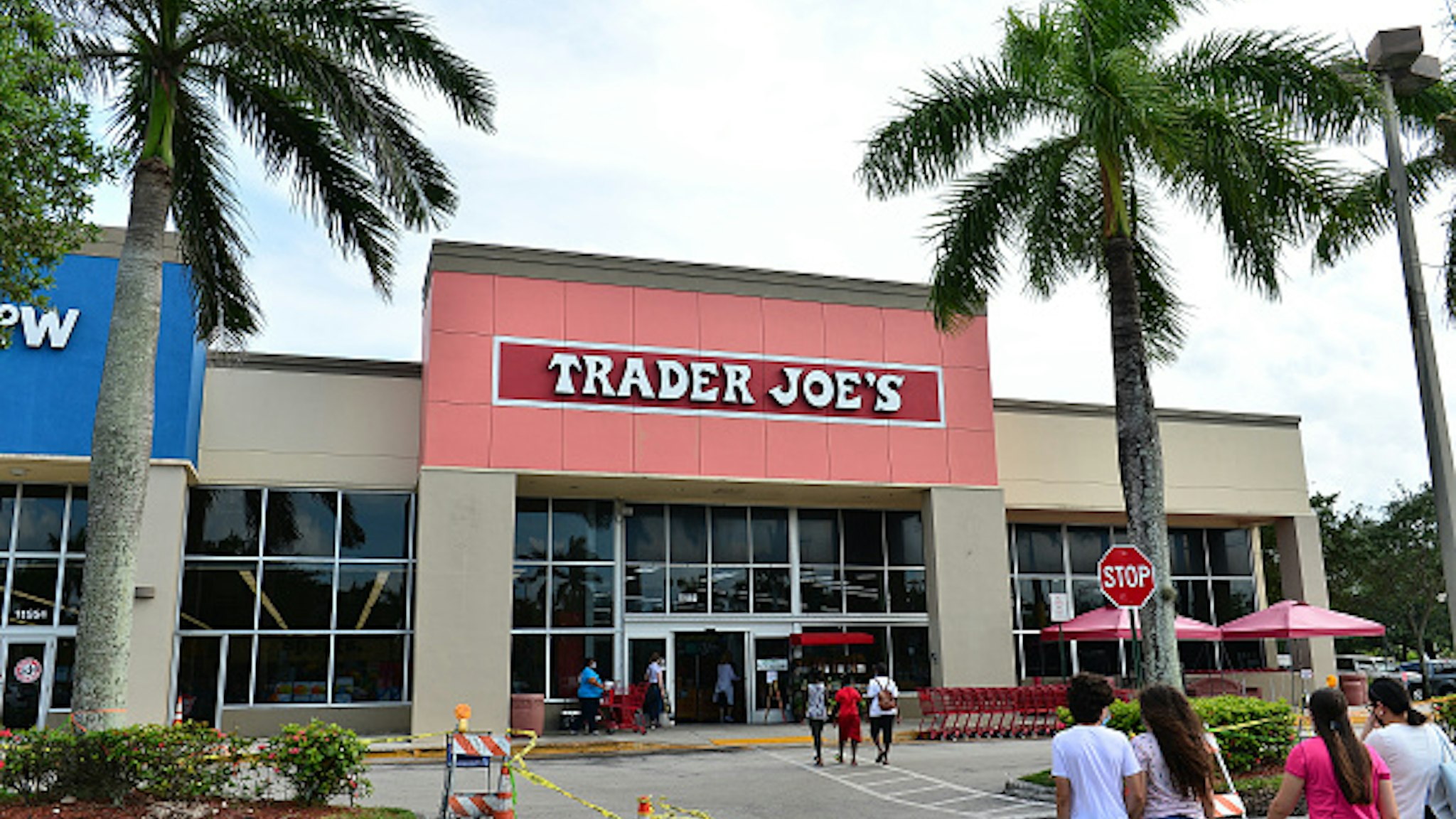 PEMBROKE PINES, FLORIDA - JULY 16: Customers wearing face masks enter a Trader Joe's store on July 16, 2020 in Pembroke Pines, Florida. Some major U.S. corporations are requiring masks to be worn in their stores upon entering to control the spread of COVID-19.