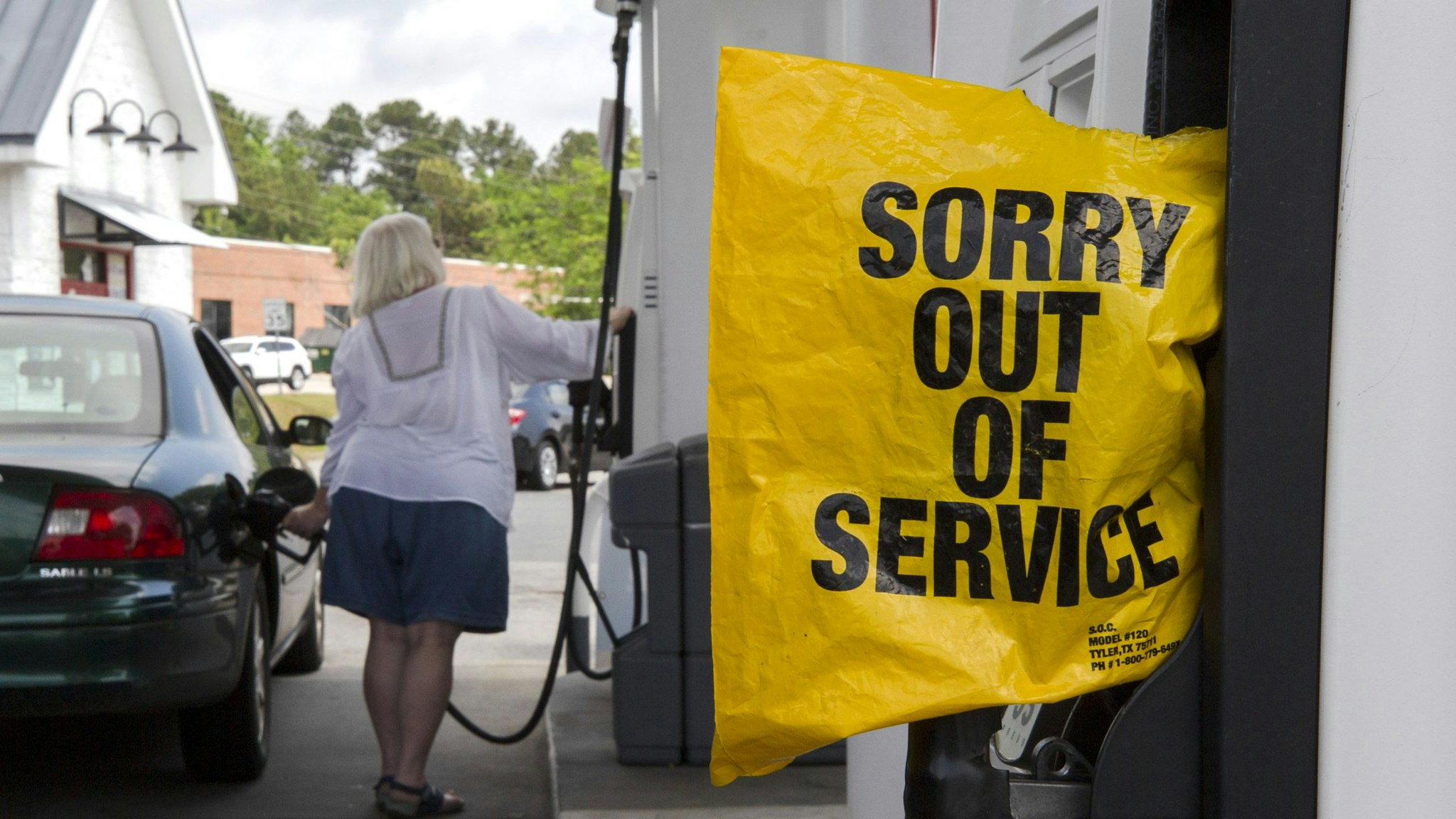 A "Sorry Out Of Service" bag covers a fuel pump at a Royal Dutch Shell gas station on Broad Street in Sumter, South Carolina, U.S., on Tuesday, May 11, 2021. Motorists across a broad swath of the U.S. East Coast and South are struggling to find gasoline and diesel as filling stations run dry amid the unprecedented pipeline disruption caused by a criminal hack.