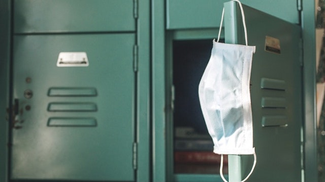 COVID-19 School, Face Mask School - stock photo Surgical mask hanging inside school on locker. School re-openings were a controversial part of the Coronavirus pandemic, COVID-19 pandemic during 2020 and 2021. Jena Ardell via Getty Images