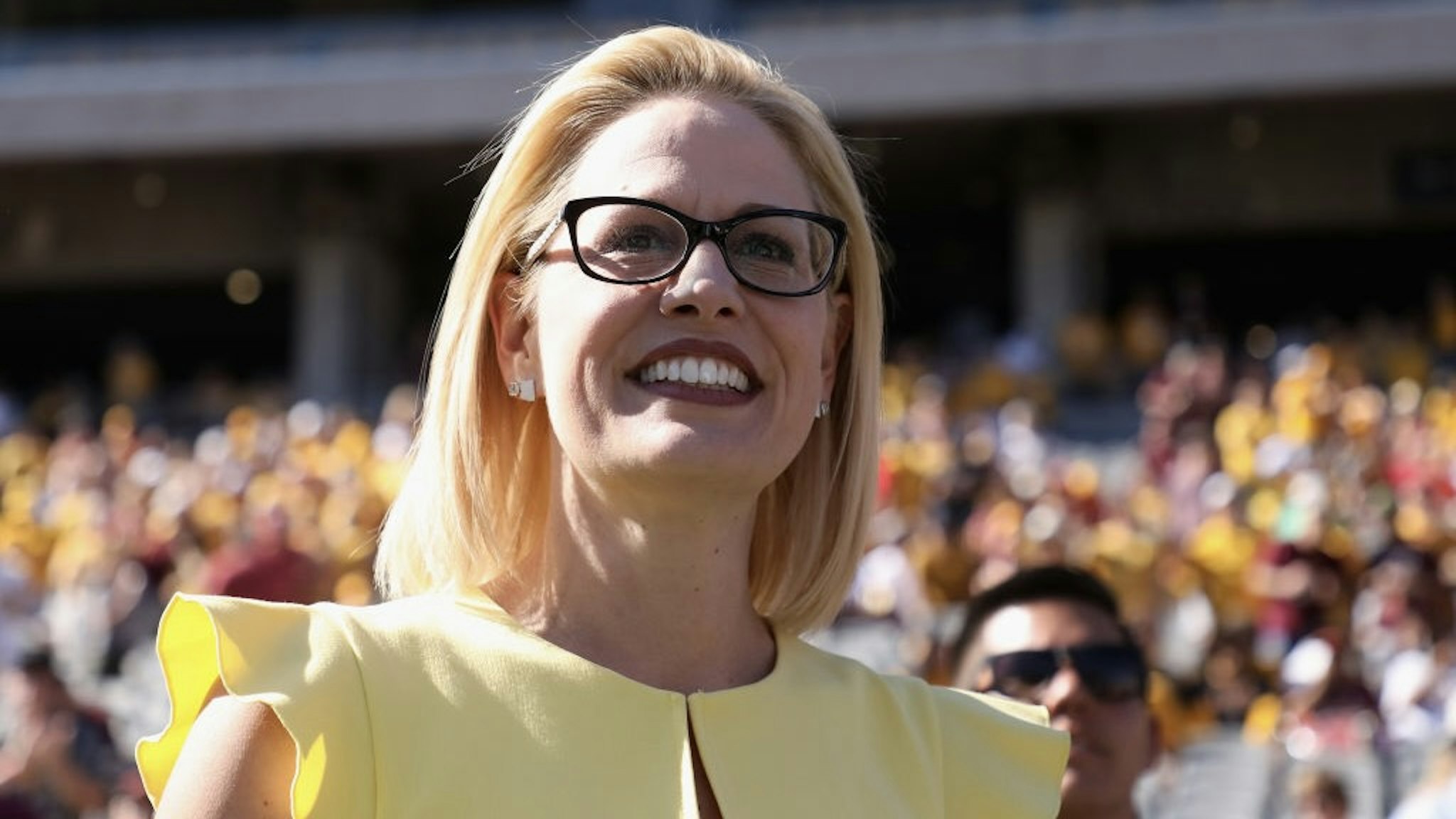 Arizona Senate Candidates Attend Arizona State Football Game TEMPE, AZ - NOVEMBER 03: Democrat U.S. Senate candidate Kyrsten Sinema participates in the pregame coin toss before the game between the Utah Utes and the Arizona State Sun Devils at Sun Devil Stadium on November 3, 2018 in Tempe, Arizona. Sinema is running against two-term congresswoman Martha McSally. (Photo by Christian Petersen/Getty Images) Christian Petersen / Staff via Getty Images