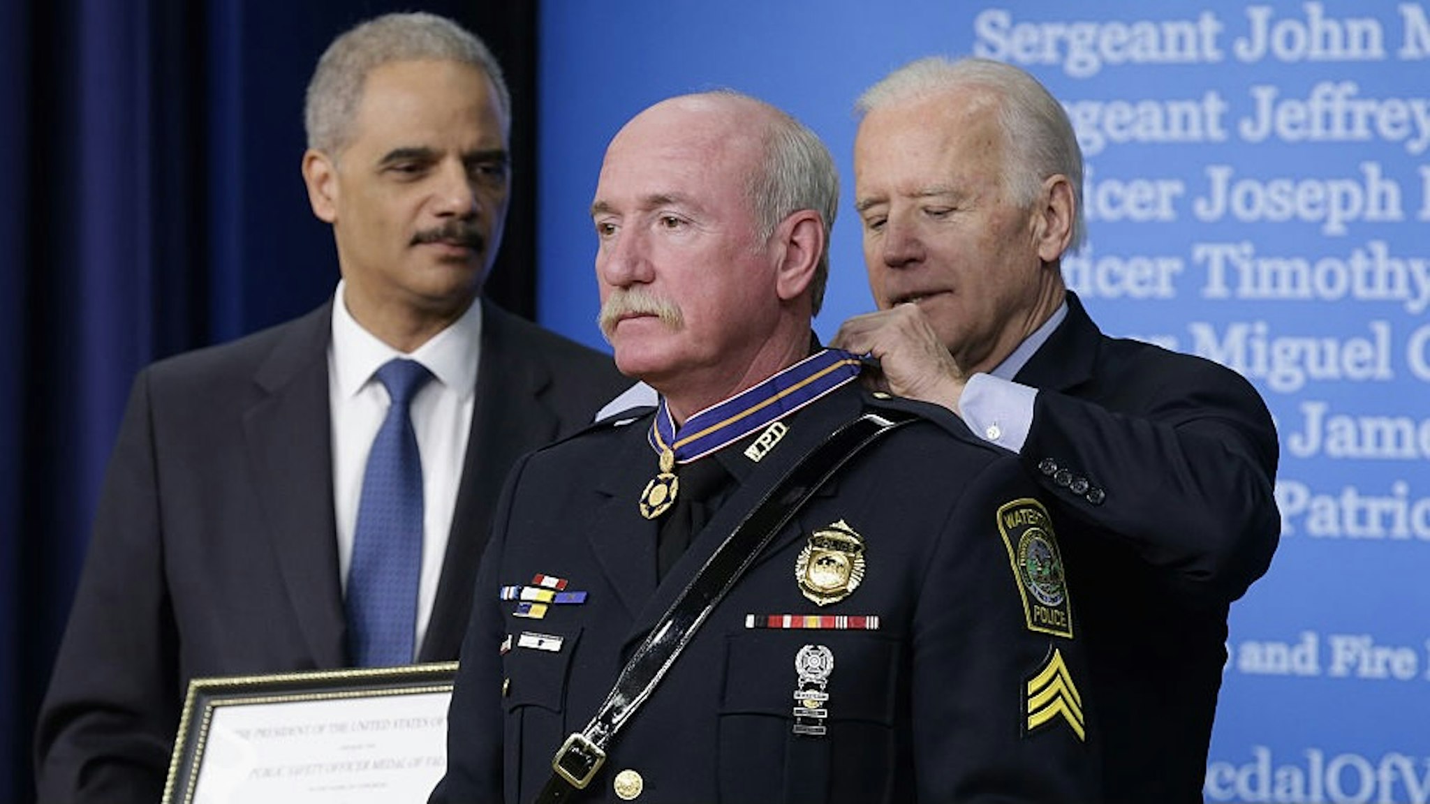 VP Biden And Attorney Gen. Holder Speak At Medal Of Valor Ceremony WASHINGTON, DC - FEBRUARY 11: U.S. Vice President Joe Biden (R) awards Watertown, Massachusetts, Police Sergeant Jeffrey Pugliese with the Public Safety Officer Medal of Valor during a ceremony with Attorney General Eric Holder (L) in the South Court Auditorium at the Eisenhower Executive Office Building February 11, 2015 in Washington, DC. According to the White House, Pugliese was one of several officers and fire fighters who battled with the Boston Marathon bombing suspects, resulting in the death of Tamerlan Tsarnaev and the eventual capture of his brother, Dzhokhar. The medal is the highest national award for valor by a public safety officer who exhibits 'exceptional courage, extraordinary decisiveness, presence of mind and unusual swiftness of action, regardless of his or her personal safety, in an attempt to save or protect human life.' (Photo by Chip Somodevilla/Getty Images) Chip Somodevilla / Staff via Getty Images
