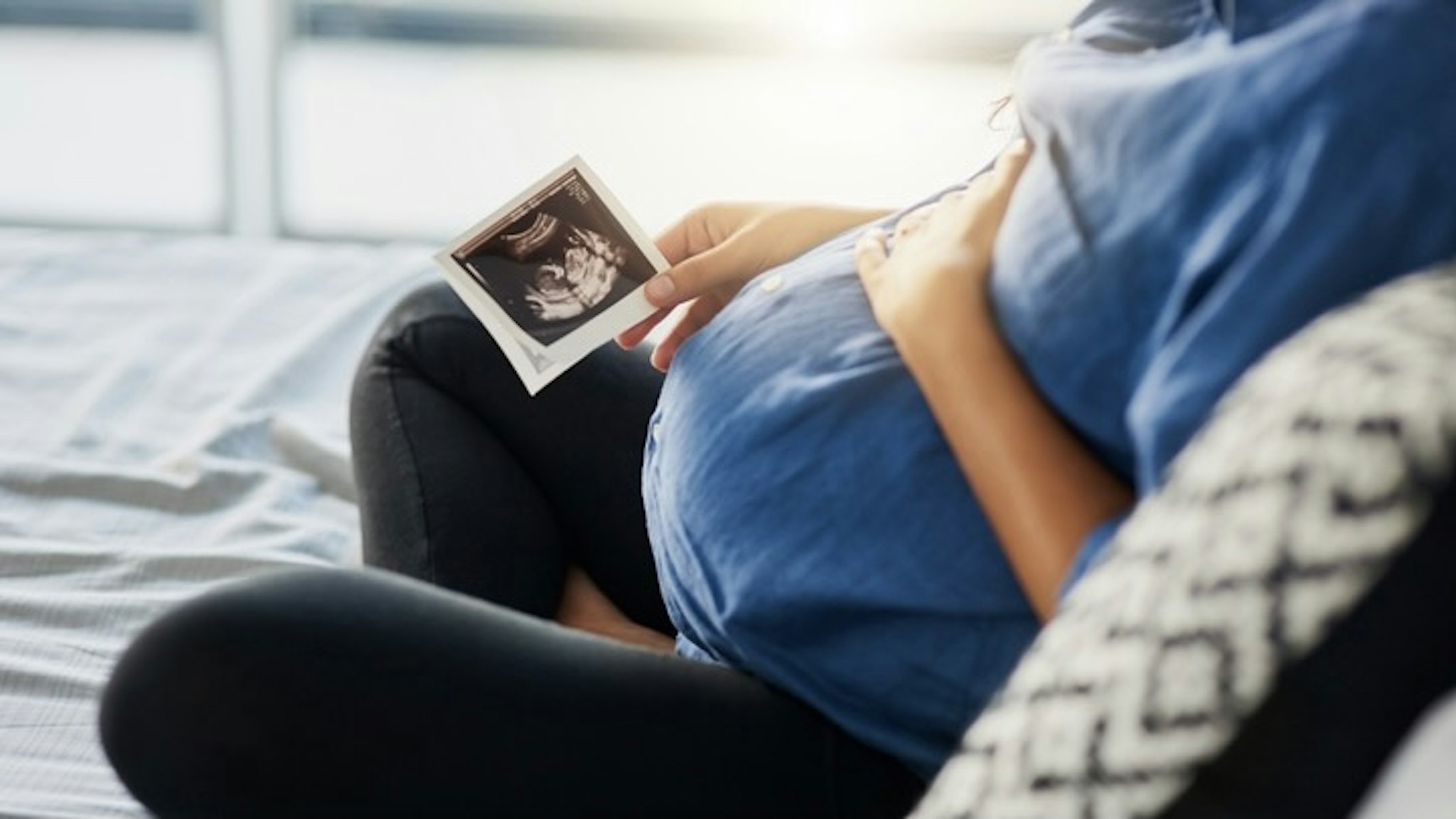 The beginning of a beautiful bond - stock photo Closeup shot of an unrecognizable pregnant woman holding an ultrasound scan Adene Sanchez via Getty Images