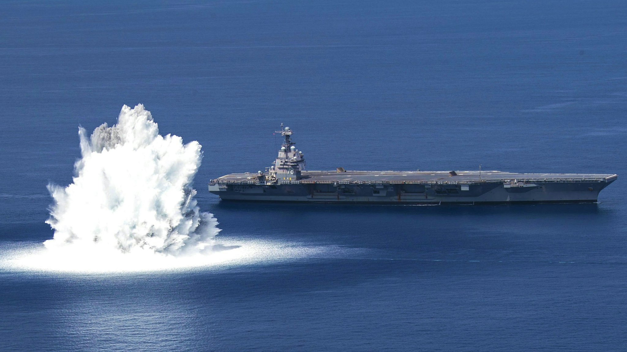 The aircraft carrier USS Gerald R. Ford (CVN 78) completes the first scheduled explosive event of Full Ship Shock Trials while underway in the Atlantic Ocean, June 18, 2021. The U.S. Navy conducts shock trials of new ship designs using live explosives to confirm that our warships can continue to meet demanding mission requirements under harsh conditions they might encounter in battle.