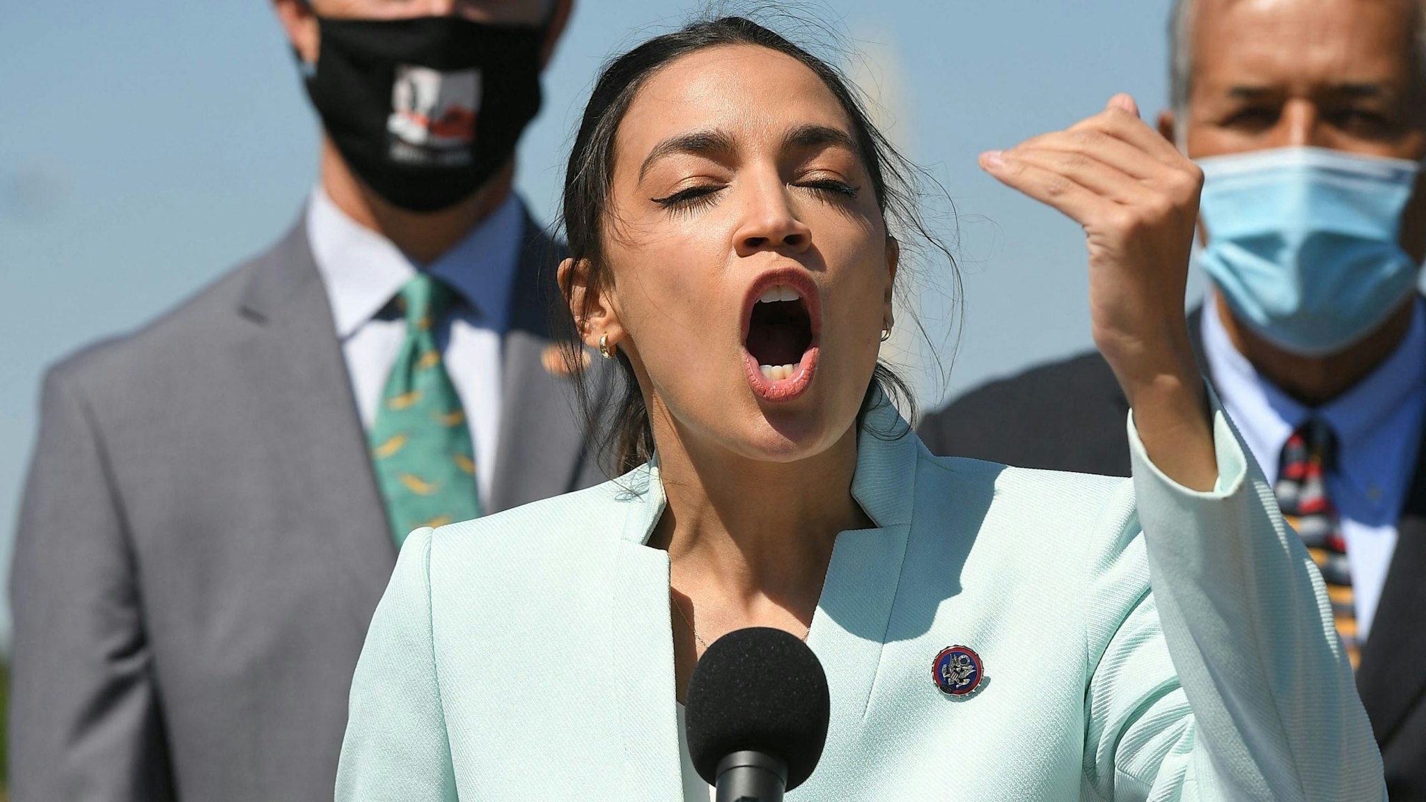 Representative Alexandria Ocasio-Cortez(D-NY) next to Senator Ed Markey(R), D-MA, speaks during a press conference to re-introduce the Green New Deal in front of the US Capitol in Washington, DC on April 20, 2021.