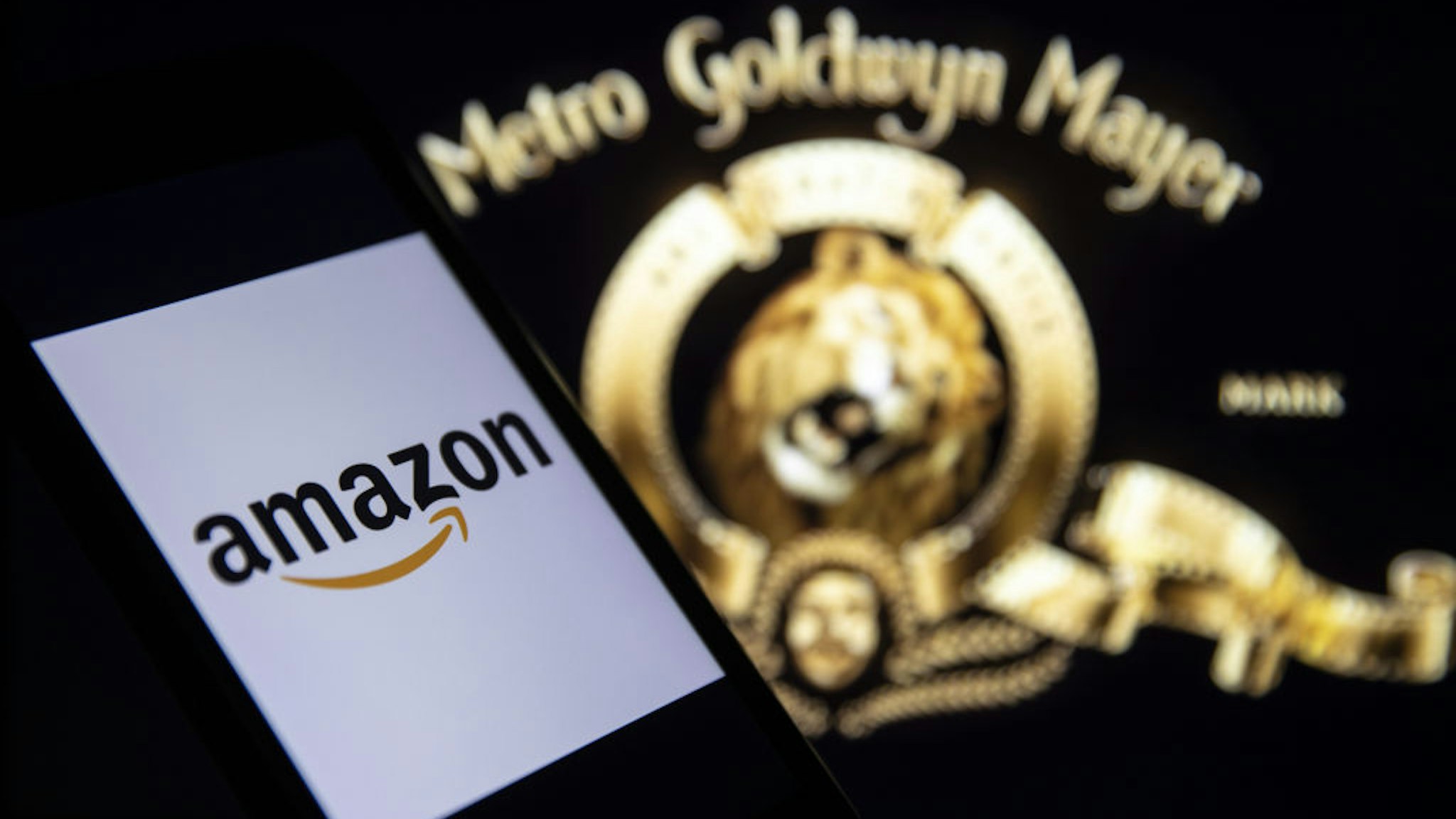 In this illustration photo Amazon logo is displayed on a smart phone screen with Goldwyn Mayer (MGM), in Ankara, Turkey on June 3, 2021. (Photo by Muhammed Selim Korkutata/Anadolu Agency via Getty Images)