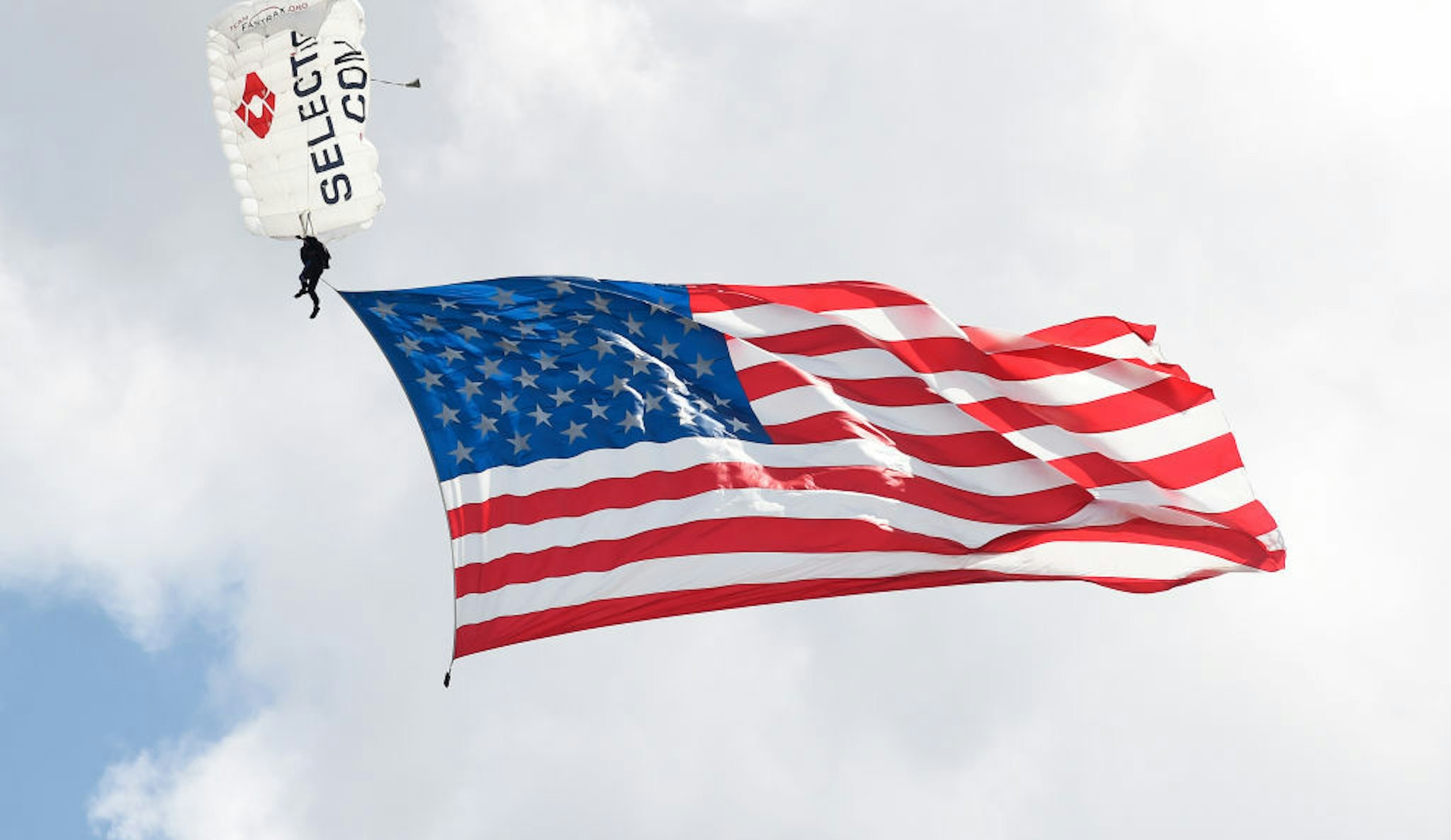 LEBANON, TENNESSEE - JUNE 20: Skydivers from Team Fastrax parachute with an American flag during pre-race ceremonies prior to the NASCAR Cup Series Ally 400 at Nashville Superspeedway on June 20, 2021 in Lebanon, Tennessee. (Photo by Logan Riely/Getty Images)