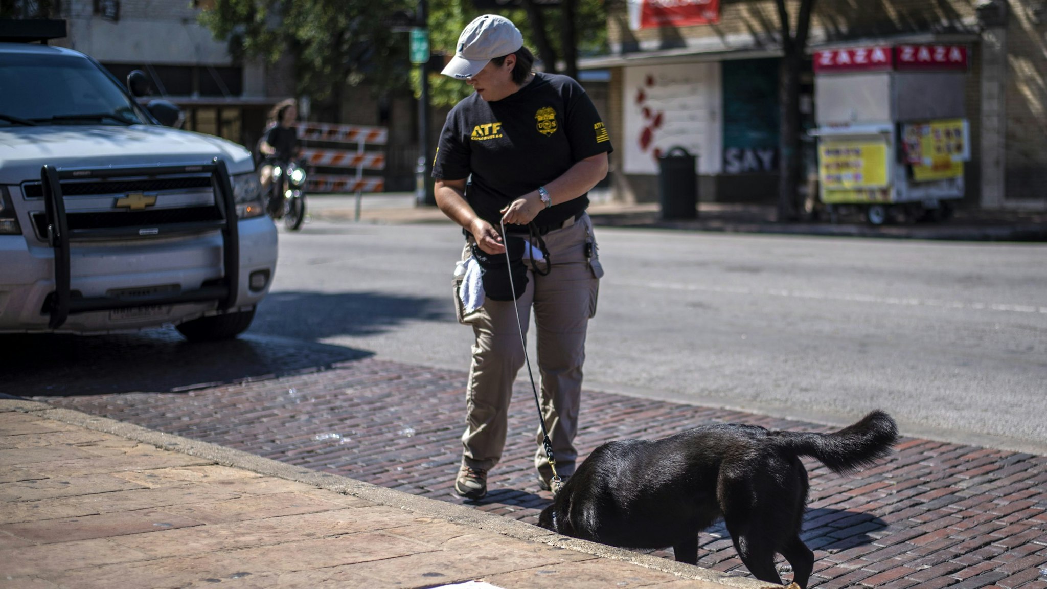 AUSTIN, TX - JUNE 12: An ATF K9 unit surveys the area near the scene of a shooting on June 12, 2021 in Austin, Texas. At least 13 people were taken to hospitals after a shooting happened on Austin's famous 6th Street. The shooter is still at large.