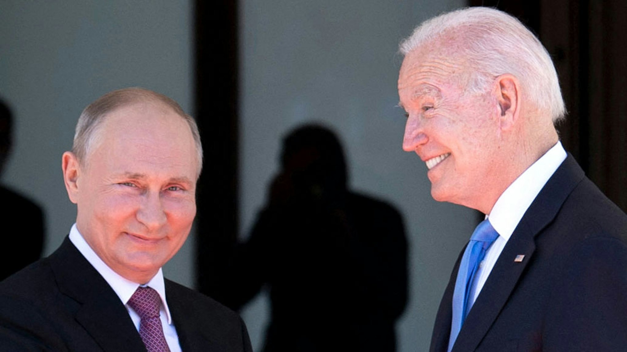 TOPSHOT - Russian President Vladimir Putin (L) shakes hands with US President Joe Biden prior to the US-Russia summit at the Villa La Grange, in Geneva on June 16, 2021.