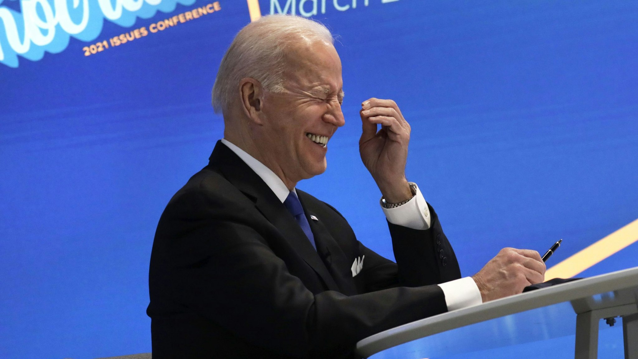U.S. President Joe Biden laughs during a virtual meeting with the House Democratic Caucus in the Eisenhower Executive Office Building in Washington, D.C., U.S., on Wednesday, March 3, 2021. Biden has agreed to moderate Democrats' demands to narrow eligibility for stimulus checks, but rejected a push to trim extra unemployment benefits, as he tries to win support for his $1.9 trillion pandemic-relief bill, according to a Democratic aide.