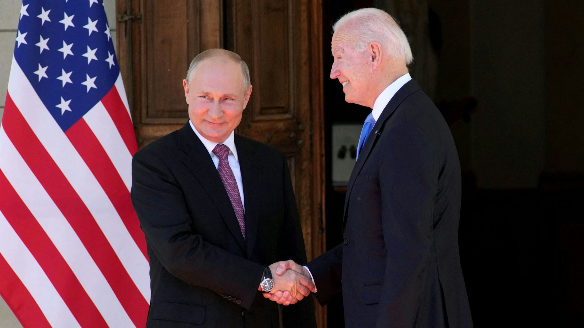Russian President Vladimir Putin (L) shakes hands with US President Joe Biden during their meeting at the 'Villa la Grange' in Geneva on June 16, 2021.