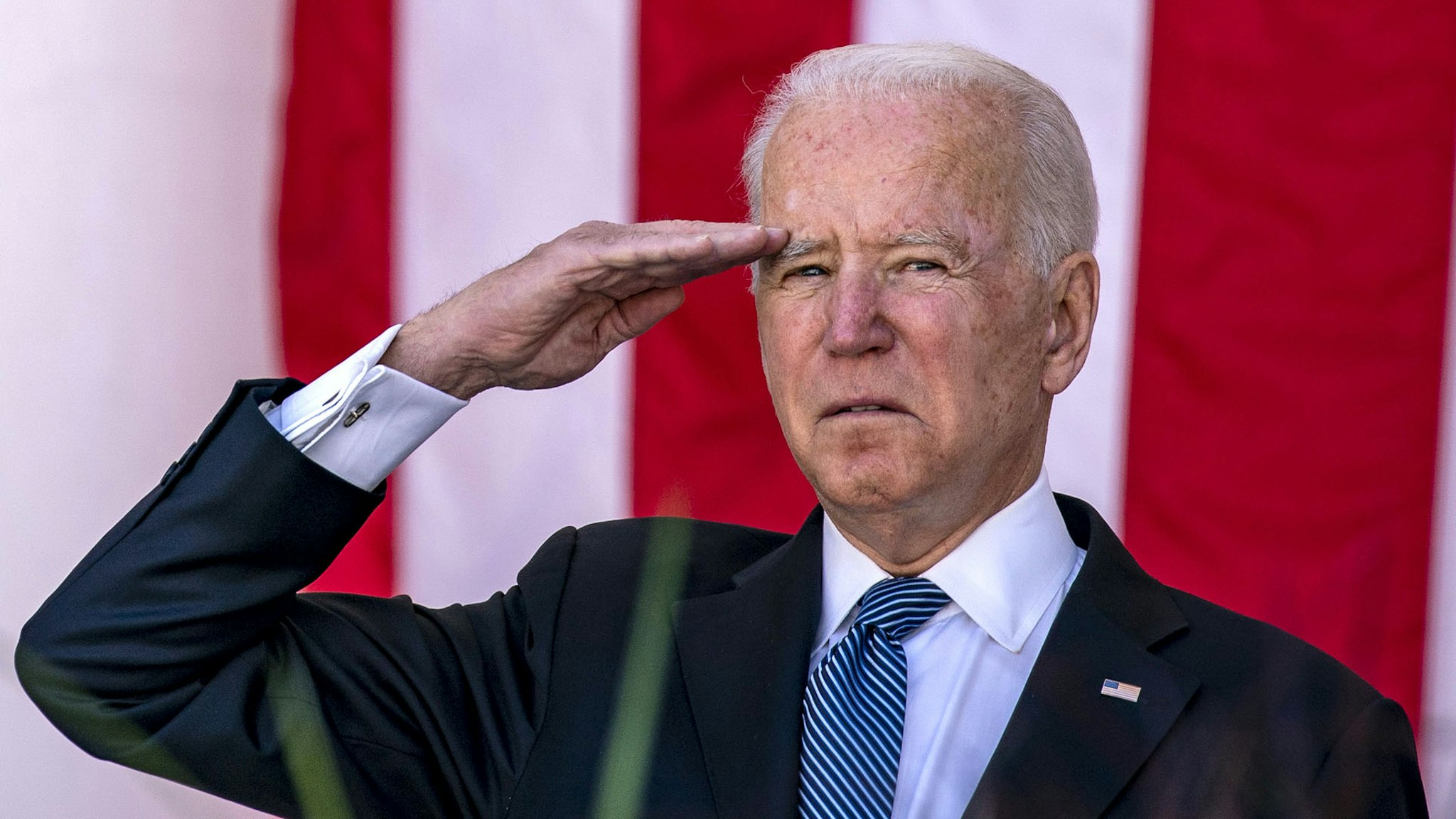 U.S. President Joe Biden saalutes during a Memorial Day ceremony at Arlington National Cemetery in Arlington, Virginia, U.S., on Monday, May 31, 2021. Biden's $6 trillion budget request proposes record spending to reduce historical disparities in underserved communities, following his campaign pledge to promote racial equity as an inseparable part of rebuilding the economy.