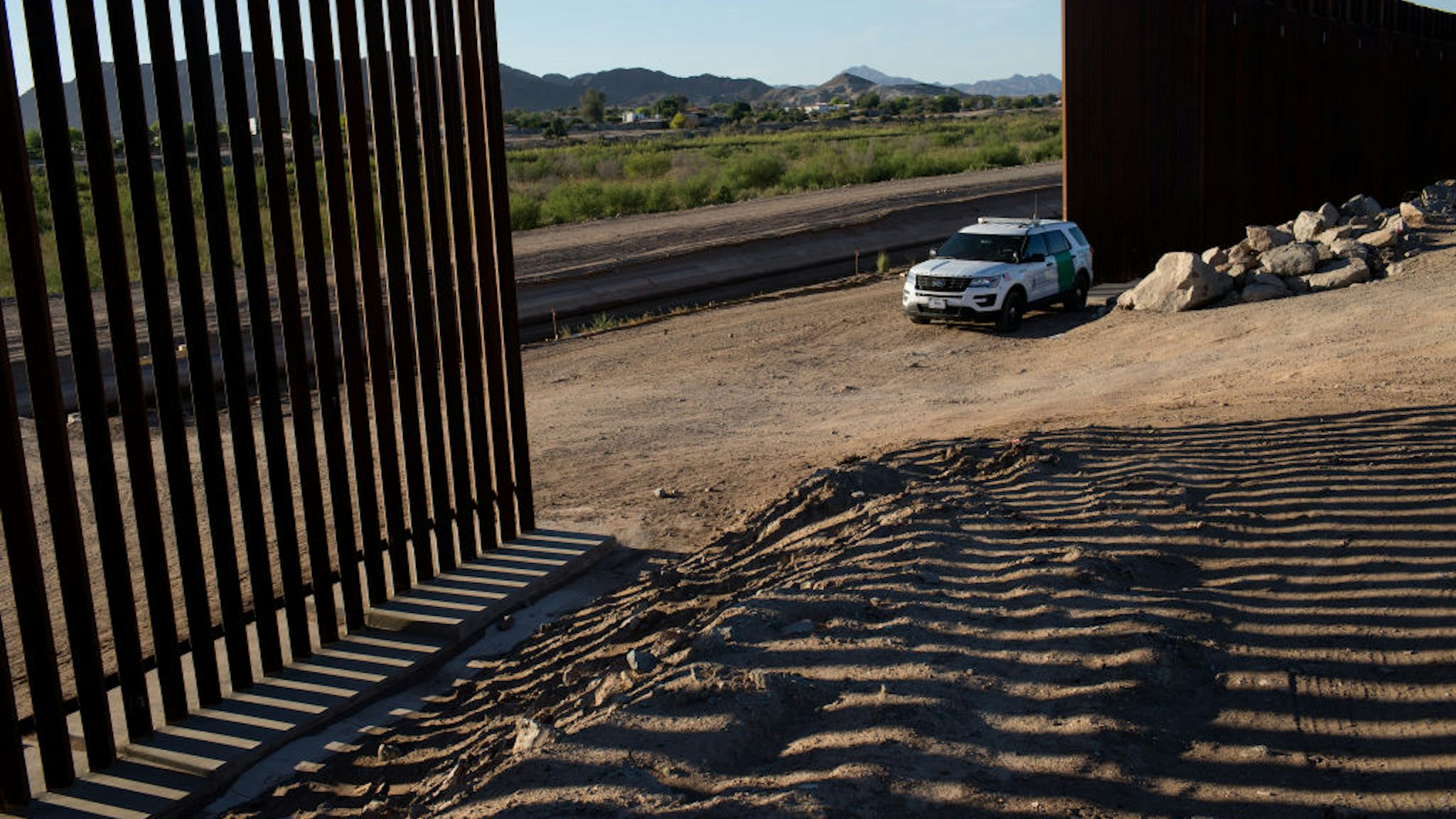 YUMA, ARIZONA - APRIL 30: United States Border Patrol agents guard a gap in the new border wall along the Colorado River where families from Central and South America have been crossing into the United States from Mexico to ask for asylum, April 30, 2021 outside of Yuma, Arizona. (Photo by Andrew Lichtenstein/Corbis via Getty Images)