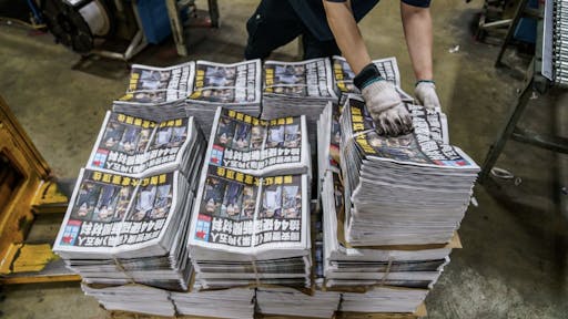 C42256EB-F52F-447F-A3B5-00226282C175_1_201_a Printing of the Apple Daily Following Police Arrest of Top Editors Citing Security Law An employee arranges bundles of the Apple Daily newspaper, published by Next Digital Ltd., at the company's printing facility in Hong Kong, China, early on Friday, June 18, 2021. China took another step toward extinguishing any form of dissent in Hong Kong, hailing police in the city for arresting top editors of the pro-democracy Apple Daily and warning journalists not to write articles that challenge Beijing. Photographer: Lam Yik/Bloomberg via Getty Images Bloomberg / Contributor via Getty Images