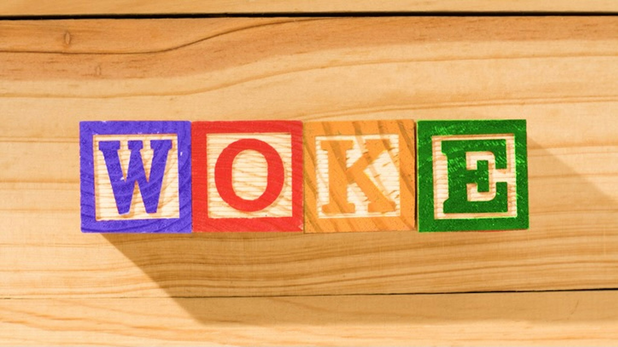 Spectacular wooden cubes with the word WOKE on a wooden surface. - stock photo Spectacular wooden cubes with the word WOKE on a wooden surface. Alexander Sanchez via Getty Images