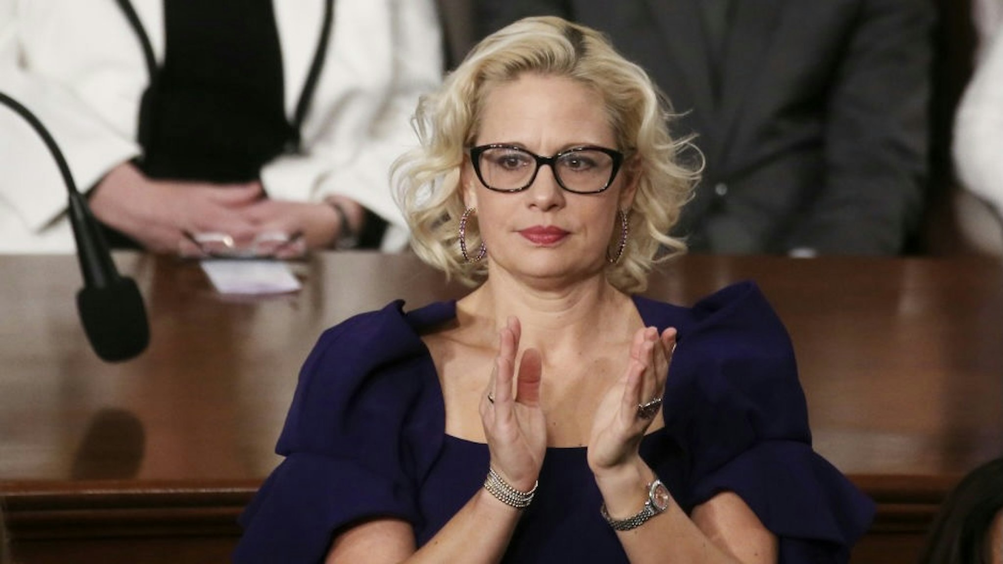 President Trump Gives State Of The Union Address WASHINGTON, DC - FEBRUARY 04: Sen. Krysten Sinema (D-AZ) applauds during the State of the Union address in the chamber of the U.S. House of Representatives on February 04, 2020 in Washington, DC. President Trump delivers his third State of the Union to the nation the night before the U.S. Senate is set to vote in his impeachment trial. (Photo by Mario Tama/Getty Images) Mario Tama / Staff via Getty Images