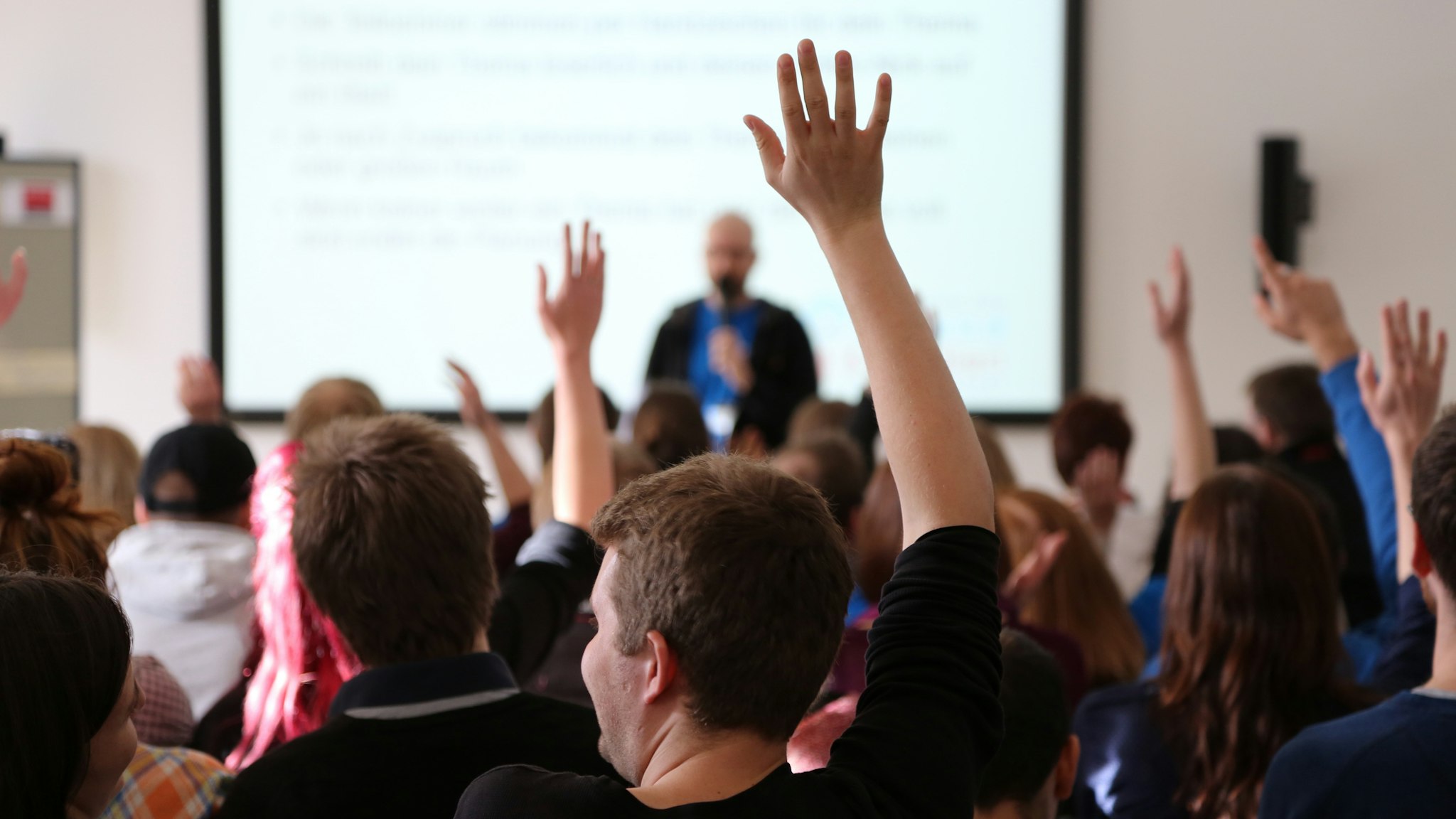 Students Raising Hands During Seminar