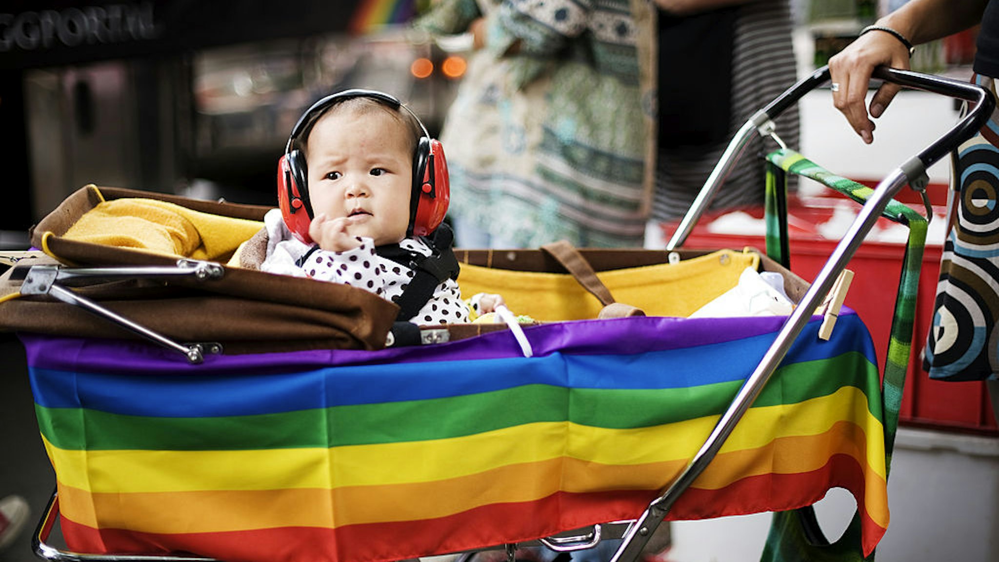 A child with ear-protection gear looks on during the HBTQ festival "Stockholm Pride" parade on August 6, 2011 in central Stockholm.
